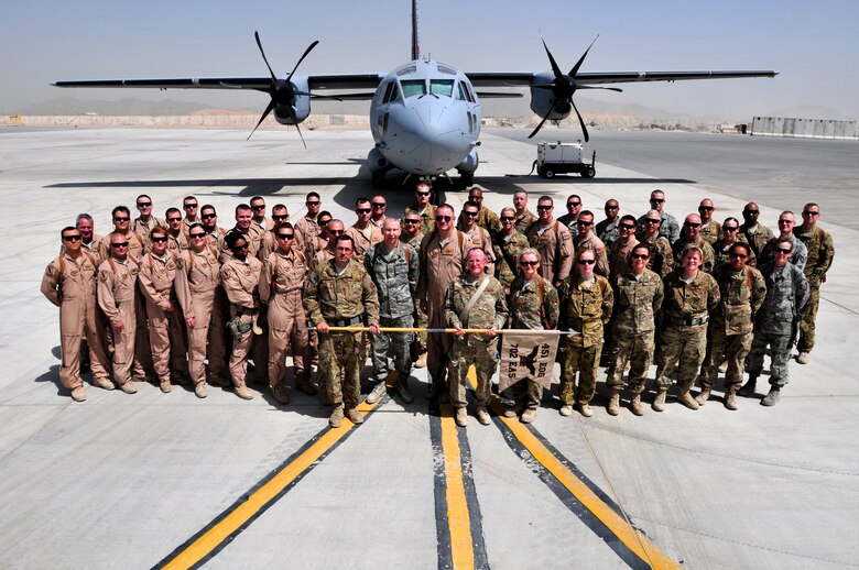 The men and women of the 702nd Expeditionary Airlift Squadron gather for a group photo before the start of their deactivation ceremony.  The squadron was established in July 2011 and was deactivated on Monday.  The squadron supported tactical airlift requirements in support of operations in Afghanistan (U.S. Army Photo - Sgt. Daniel J. Schroeder)