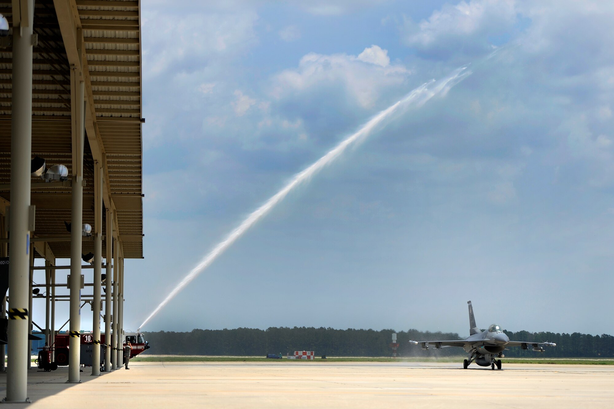 U.S. Air Force Col. Don Godier, 20th Fighter Wing vice commander, has his jet sprayed down after completing his final flight, June 19, 2012, Shaw Air Force Base, S.C. The flight was Godier’s last with the 20th FW before moving on to his next assignment at Osan Air Base, South Korea. (U.S. Air Force photo by Senior Airman Kenny Holston)