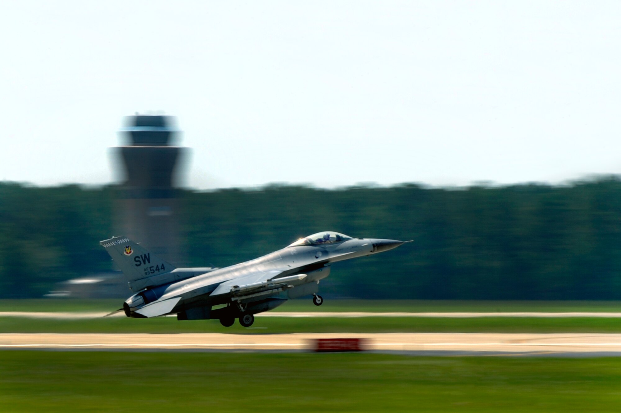 U.S. Air Force Col. Don Godier, 20th Fighter Wing vice commander, streaks past the Shaw flight tower at he takes off for his final flight, June 19, 2012, Shaw Air Force Base, S.C. The flight was Godier’s last with the 20th FW before moving on to his next assignment at Osan Air Base, South Korea. (U.S. Air Force photo by Senior Airman Kenny Holston)