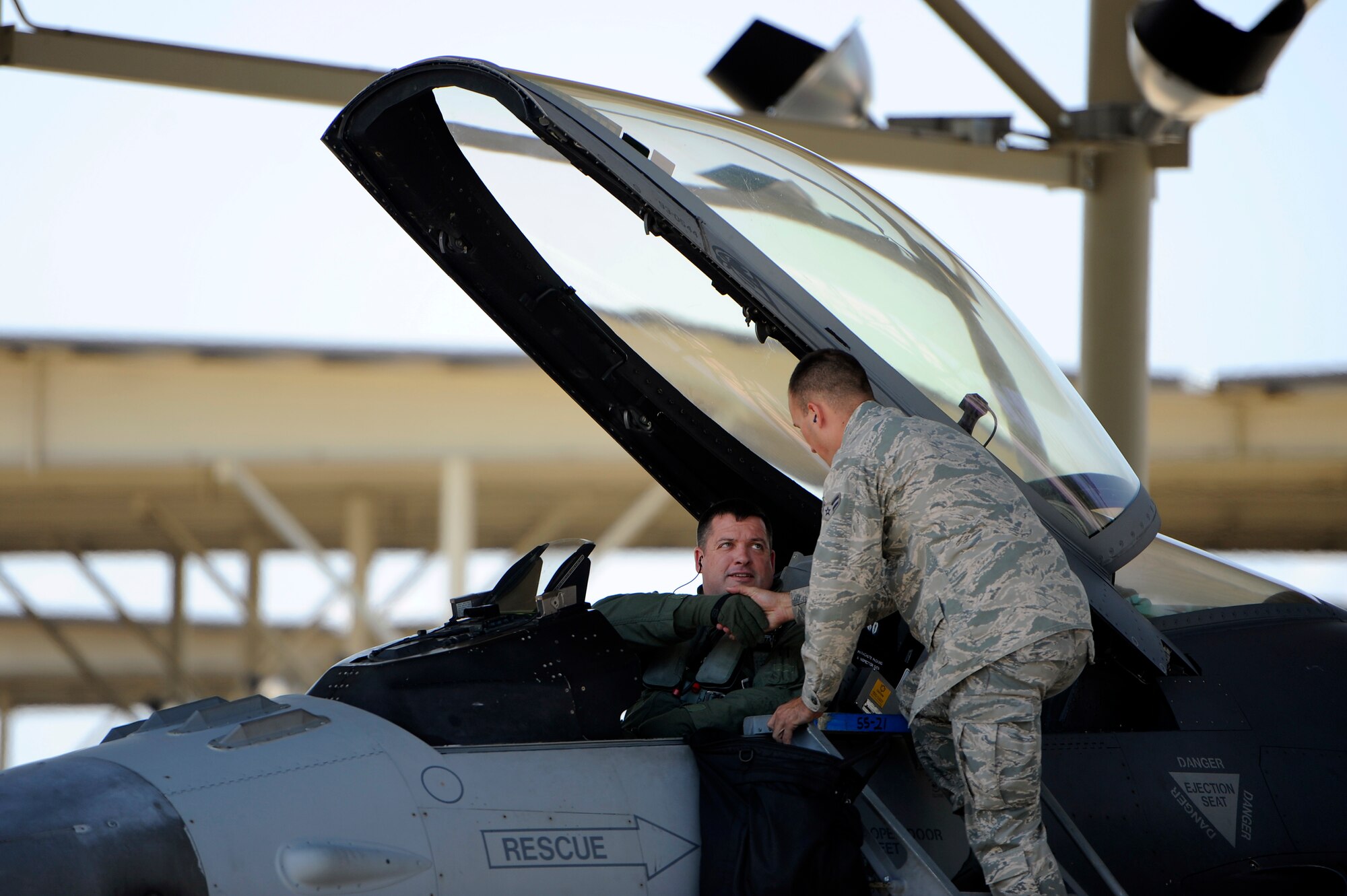 U.S. Air Force Col. Don Godier, 20th Fighter Wing vice commander, (left) shakes the hand of Airman 1st Class Brian Fisher, 20th Aircraft Maintenance Squadron crew chief, before taking off for his final flight, June 19, 2012, Shaw Air Force Base, S.C. The flight was Godier’s last with the 20th FW before moving on to his next assignment at Osan Air Base, South Korea. (U.S. Air Force photo by Senior Airman Kenny Holston)
