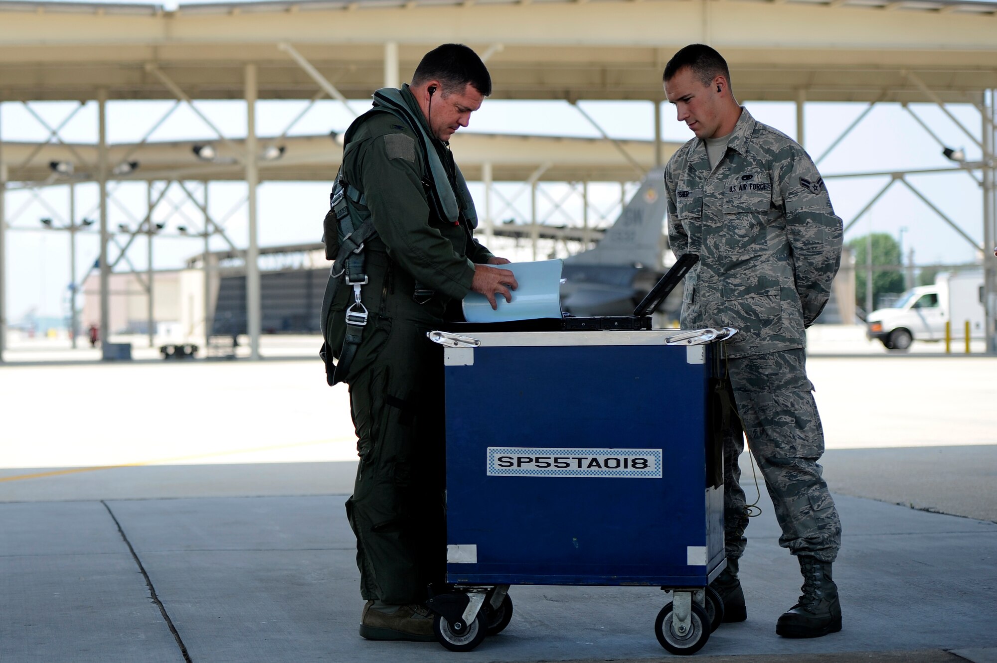 U.S. Air Force Col. Don Godier, 20th Fighter Wing vice commander, (left) and Airman 1st Class Brian Fisher, 20th Aircraft Maintenance Squadron crew chief, go through standard preflight methods before Godier’s final flight, June 19, 2012, Shaw Air Force Base, S.C. The flight was Godier’s last with the 20th FW before moving on to his next assignment at Osan Air Base, South Korea. (U.S. Air Force photo by Senior Airman Kenny Holston)