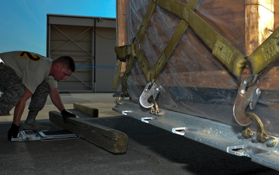 Tech. Sgt. Todd Losch Jr., 32nd Aerial Port Squadron air transportation specialist, prepares to weigh a loaded pallet as part of a joint inspection exercise during the Port Dawg Challenge at Dobbins Air Reserve Base, Ga., June 19, 2012. During the exercise, aerial port members are required to ensure the weight data for the pallet is correct before loading equipment onto an aircraft and are only given an allowed weight difference of plus or minus 10 percent of the actual total. (U.S. Air Force photo by Senior Airman Joshua J. Seybert/Released)