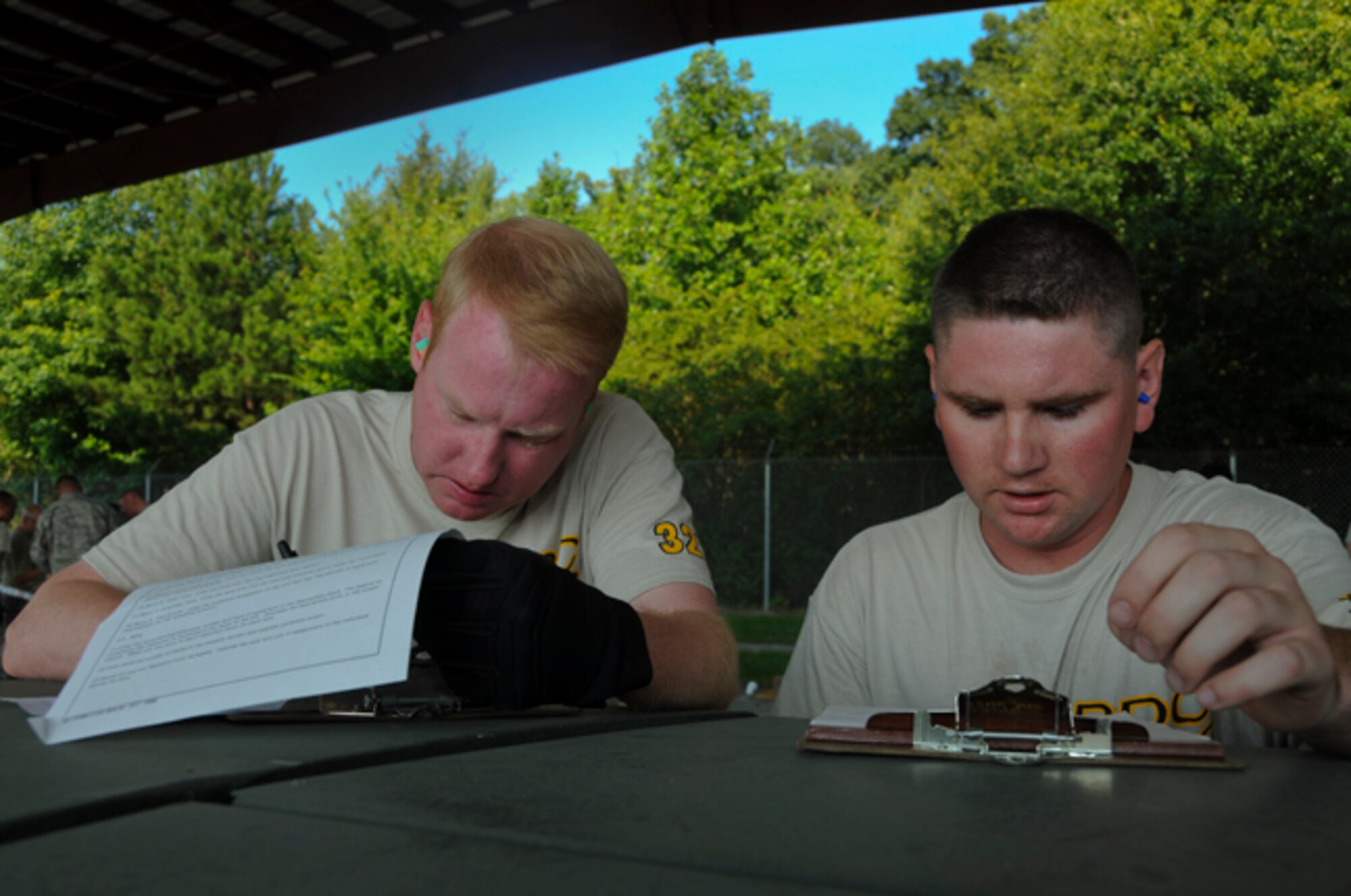 Master Sgt. Robert Steckmeyer and Tech. Sgt. Todd Losch, Jr., air transportation specialists, 32nd Aerial Port Squadron, review detailed paperwork on the hood of a Humvee during the joint inspection event at the Port Dawg Challenge held at Dobbins Air Reserve Base, Ga., June 19, 2012. The Port Dawg Challenge consists of 11 events, which test “Port Dawgs” on their knowledge and skills in their career field as well as identifying one outstanding unit for their performance. (U.S. Air Force photo by Senior Airman Joshua J. Seybert/Released) 
