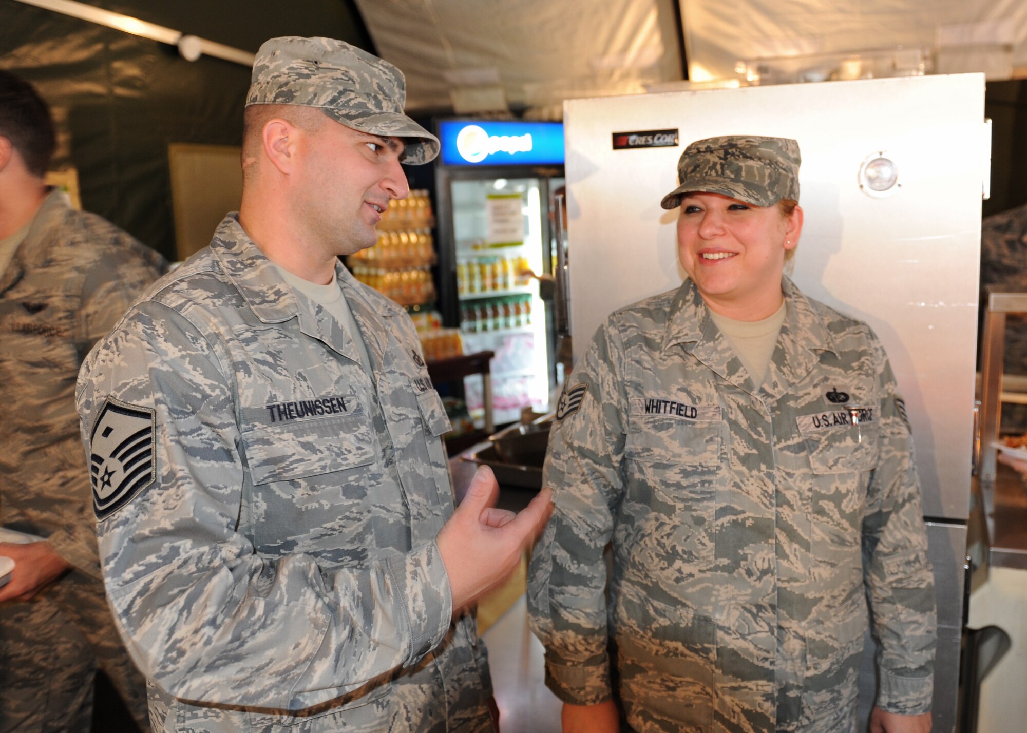 Master Sgt. Wayne Theunissen, 92nd Force Support Squadron first sergeant, speaks to Staff Sgt. Dorothy Whitfield, 92nd FSS Ross Dining Facility shift leader, in the dining tent outside of the Ross Dining Facility during the lunch service at Fairchild Air Force Base, Wash., June 13, 2012. Theunissen took time to visit with his Airmen and see how the operations were going while the dining facility was being renovated. As the first sergeant, Theunissen advises the commander on a wide range of topics including the health, esprit de corps, well being and recognition of all assigned enlisted members. (U.S. Air Force photo by Staff Sgt. Michael Means/Released)  