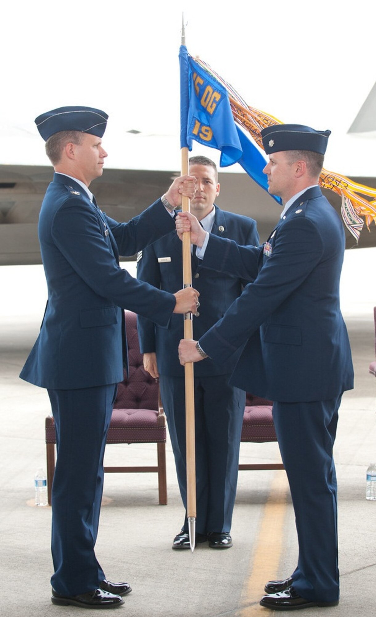 Col. Dan Baldessari, 15th Operations Group commander, presents the 19th Fighter Squadron guidon to Lt. Col. Robert Jackson, incoming 19th FS commander, upon Jackson's assumption of command June 15th at Joint Base Pearl Harbor-Hickam, Hawaii. The 19th FS returned to Hickam Sept. 10, 2010, marking the first time the squadron has been based out of Hawaii since spending 1923 through 1944 in the Hawaiian territories, including assignments at Wheeler Army Airfield, Bellows Field, and Barber's Point. (Photo by Wendy Zippwald)