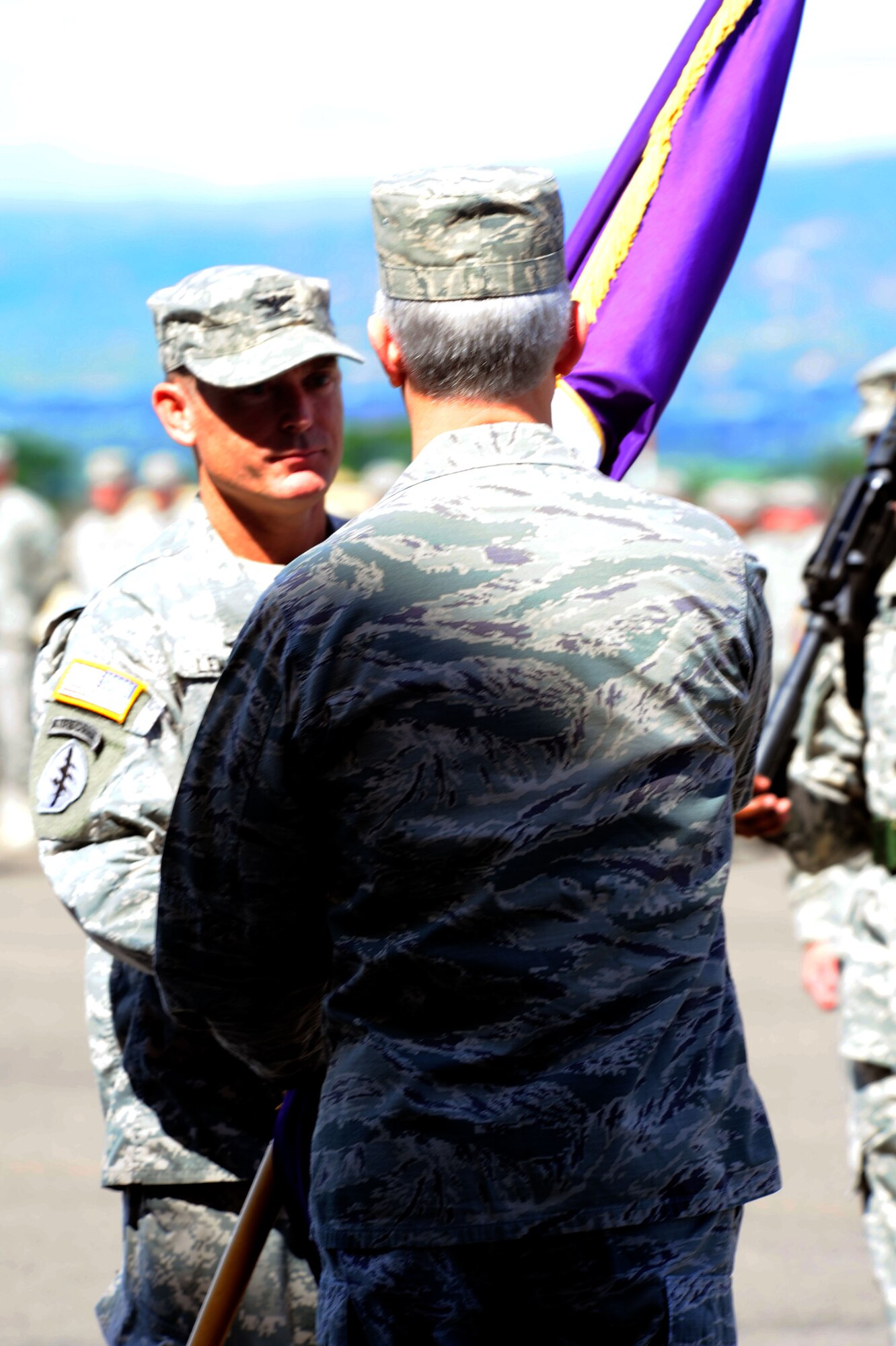 Col. Guy A LeMire receives the Joint Task Force Bravo colors from Gen. Douglas M. Fraser, Commander, U.S. Southern Command during a change of command ceremony at Soto Cano Air Base, Honduras, June 19. LeMire replaced Col. Ross A. Brown, who is leaving to take a position at the Pentagon. (Air Force photo by Martin Chahin)