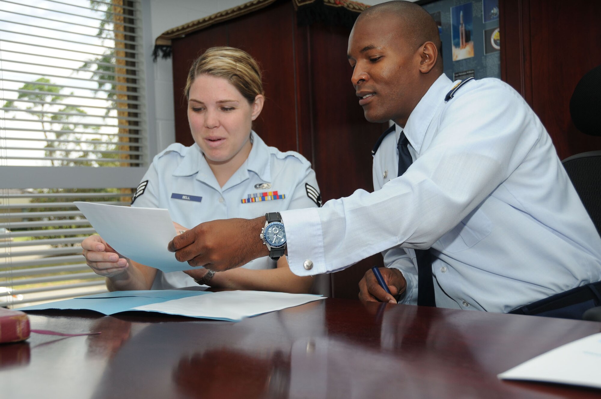 Senior Airman Amber Bell, 81st Comptroller Squadron, briefs Maj. Phelemon Williams II, 81st CPTS commander, on outstanding reenlistment payments June 18, 2012, at the Sablich Center, Keesler Air Force Base, Miss. Williams has been selected for the promotion to Lt. Col.  There were 1,269 majors selected for promotion to lieutenant colonel during the 2012A line of the Air Force and LAF-judge advocate central selection boards, Air Force Personnel Center officials announced. The boards considered 6,639 majors for promotion.  (U.S. Air Force photo by Kemberly Groue)