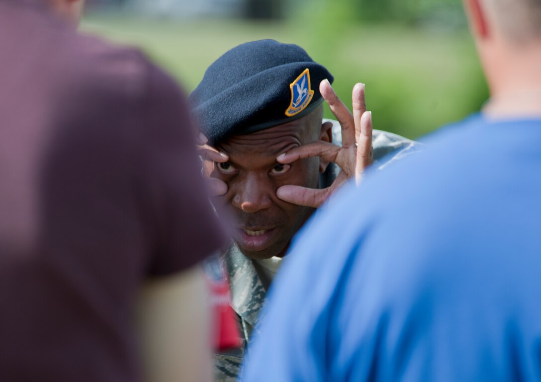 Master Sgt. Steven Hawkins, 11th Security Forces Group NCO in charge of training, shows Airman how to rinse Oleoresin Capsicum spray from their eyes June 14, 2012 during a training session at Joint Base Andrews, Md. Security forces Airman are exposed to OC spray prior to being certified to carry it so they are aware of its affects on whomever they spray, as well as themselves. OC spray is an extremely effective less-than-lethal tool that can be utilized to quell a situation without having to otherwise resort to lethal force.  (U.S. Air Force photo by Senior Airman Perry Aston)(Released)