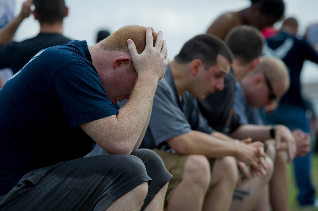 Airmen from the 11th Security Forces Group recover after being sprayed with Oleoresin Capsicum during familiarization training June 14, 2012 at Joint Base Andrews, Md. Security forces Airman are exposed to OC spray prior to being certified to carry it so they are aware of its affects on whomever they spray, as well as themselves. OC spray is an extremely effective less-than-lethal tool that can be utilized to quell a situation without having to otherwise resort to lethal force.  (U.S. Air Force photo by Senior Airman Perry Aston)(Released)