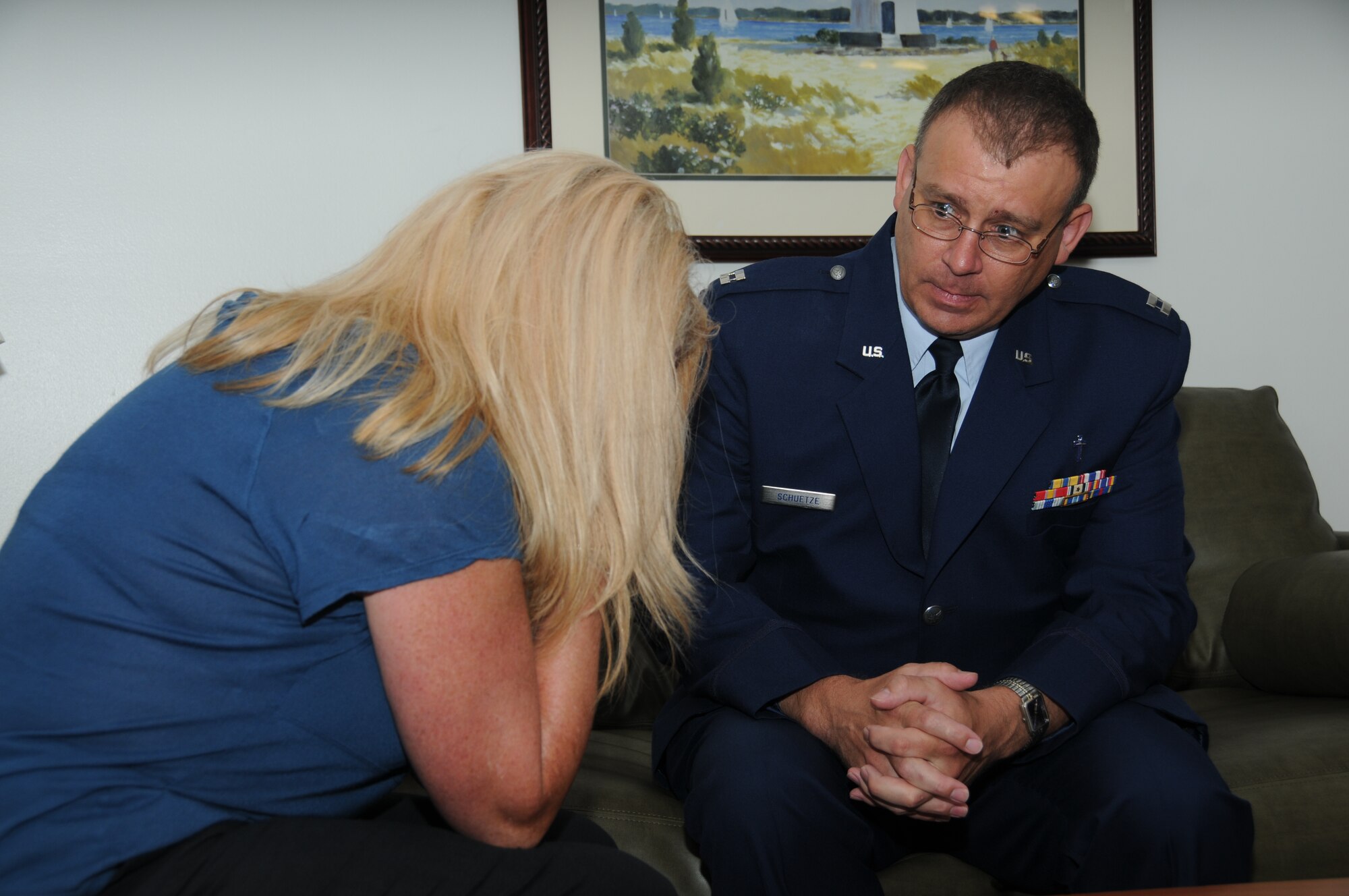 Linda Meade, 81st Force Support Squadron, is comforted by Chaplain (Capt.) John Schuetze, 81st Training Wing, who portrays a military spouse who has just been notified of the death of her husband during Keesler's active shooter exercise, June 13, 2012, at the Arnold Annex, Keesler Air Force Base, Miss. The two-day exercise consisted of a lone gunman opening fire with four people killed and 32 injured. The exercise tested the base's ability to respond and recover from a mass casualty event.  (U.S. Air Force photo by Kemberly Groue)