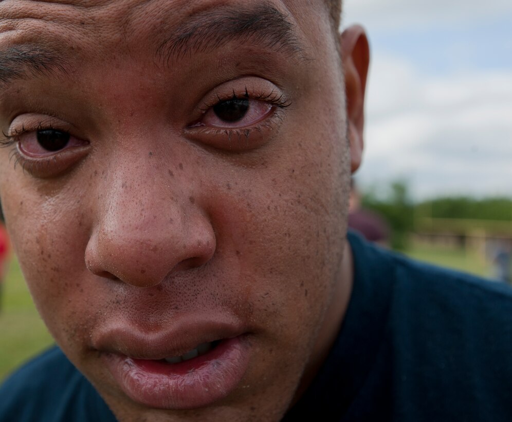 Staff Sgt. Eston Todman, 11th Security Forces Group patrolman, recovers after being sprayed with Oleoresin Capsicum during familiarization training June 14, 2012, at Joint Base Andrews, Md. Security forces Airman are exposed to OC spray prior to being certified to carry it so they are aware of its affects on whomever they spray, as well as themselves. OC spray is an extremely effective less-than-lethal tool that can be utilized to quell a situation without having to otherwise resort to lethal force.  (U.S. Air Force photo by Senior Airman Perry Aston)(Released)