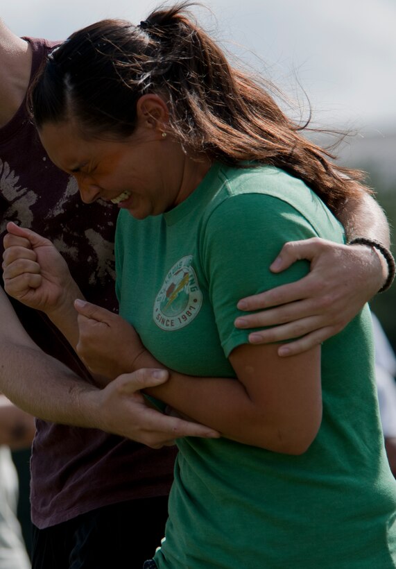 Staff Sgt. Sandy Dulac, of the 11th Security Force Group, reacts to being sprayed with Oleoresin Capsicum Spray during familiarization training June 14, 2012, at Joint Base Andrews, Md. Security forces Airman are exposed to OC spray prior to being certified to carry it so they are aware of its affects on whomever they spray, as well as themselves. OC spray is an extremely effective less-than-lethal tool that can be utilized to quell a situation without having to otherwise resort to lethal force.  (U.S. Air Force photo by Senior Airman Perry Aston)(Released)
