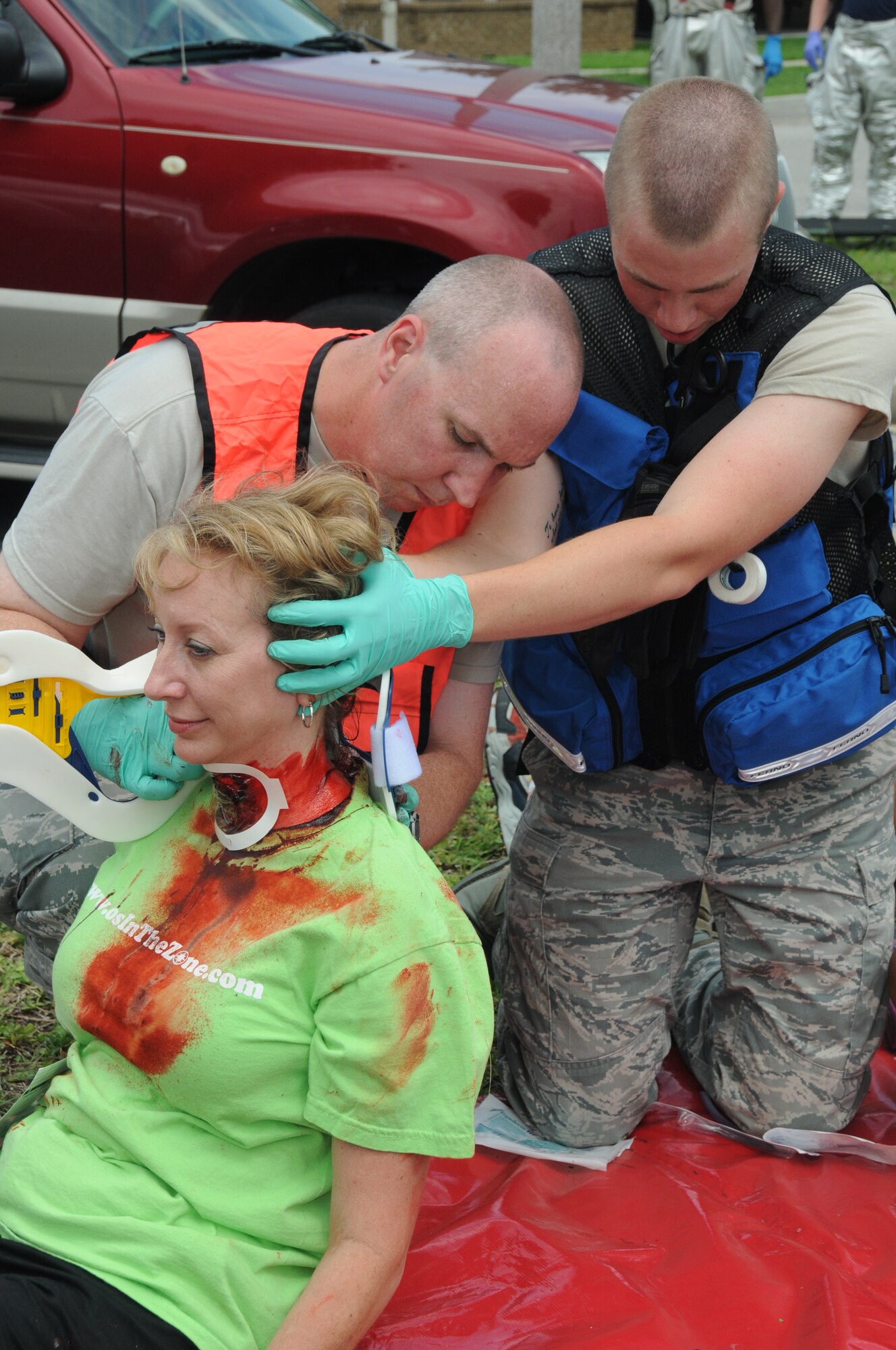 Rhonda Ferrell, 81st Medical Operations Squadron, portrays a wounded victim who is receiving medical care from Master Sgt. Lukus Hancock, 81st MDOS and Airman 1st Class Jason Parker, 81st Aerospace Medicine Squadron, during Keesler's active shooter exercise, June 12, 2012, at the Arnold Annex, Keesler Air Force Base, Miss.  The two-day exercise consisted of a lone gunman opening fire with four people killed and 32 injured. The exercise tested the base's ability to respond and recover from a mass casualty event.(U.S. Air Force photo by Kemberly Groue)