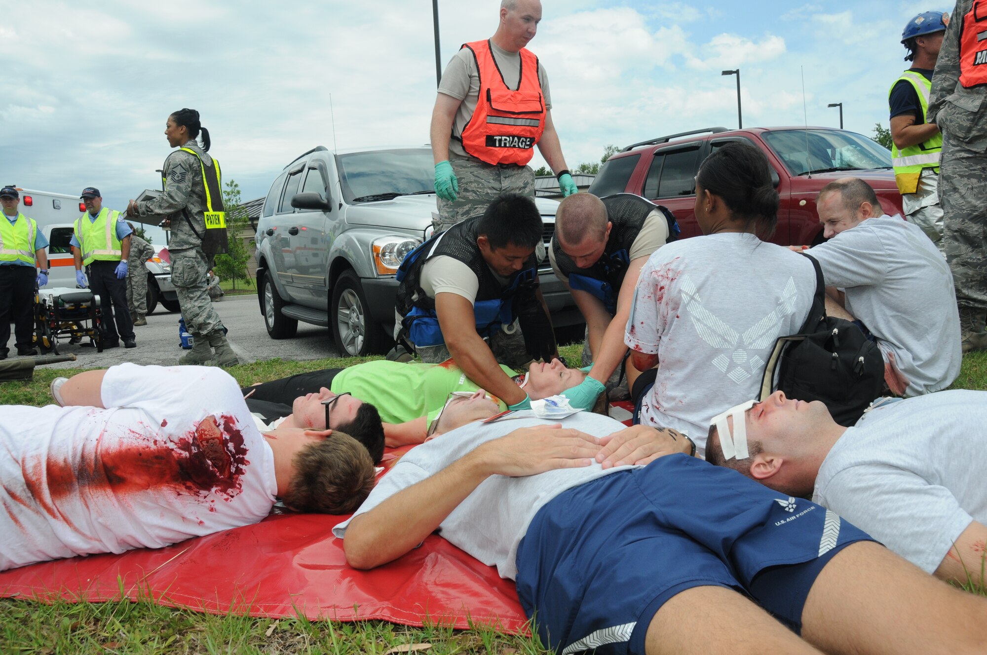 Members of the 81st Medical Group administer triage on individuals portraying wounded victims during Keesler's active shooter exercise, June 12, 2012, at the Arnold Annex, Keesler Air Force Base, Miss. The two-day exercise consisted of a lone gunman opening fire with four people killed and 32 injured. The exercise tested the base's ability to respond and recover from a mass casualty event.  (U.S. Air Force photo by Kemberly Groue)