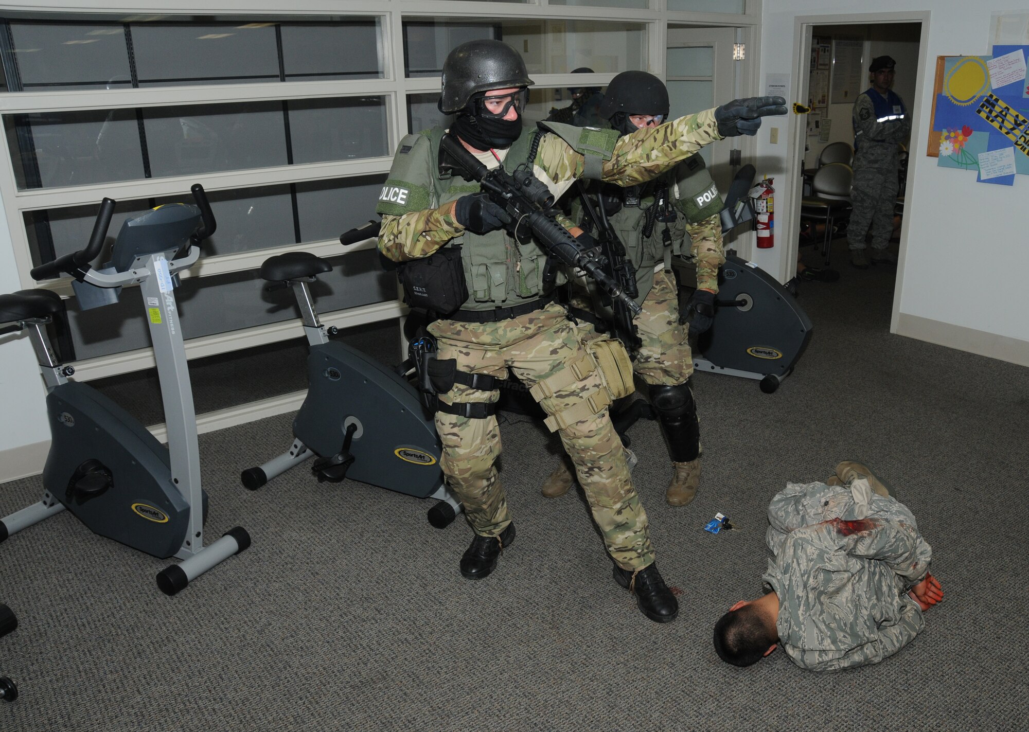 Biloxi Police Department's Special Response Team members continue their sweep after securing the active shooter suspect during Keesler's active shooter exercise, June 12, 2012, at the Arnold Annex, Keesler Air Force Base, Miss. The two-day exercise consisted of a lone gunman opening fire with four people killed and 32 injured. The exercise tested the base's ability to respond and recover from a mass casualty event.  (U.S. Air Force photo by Kemberly Groue)