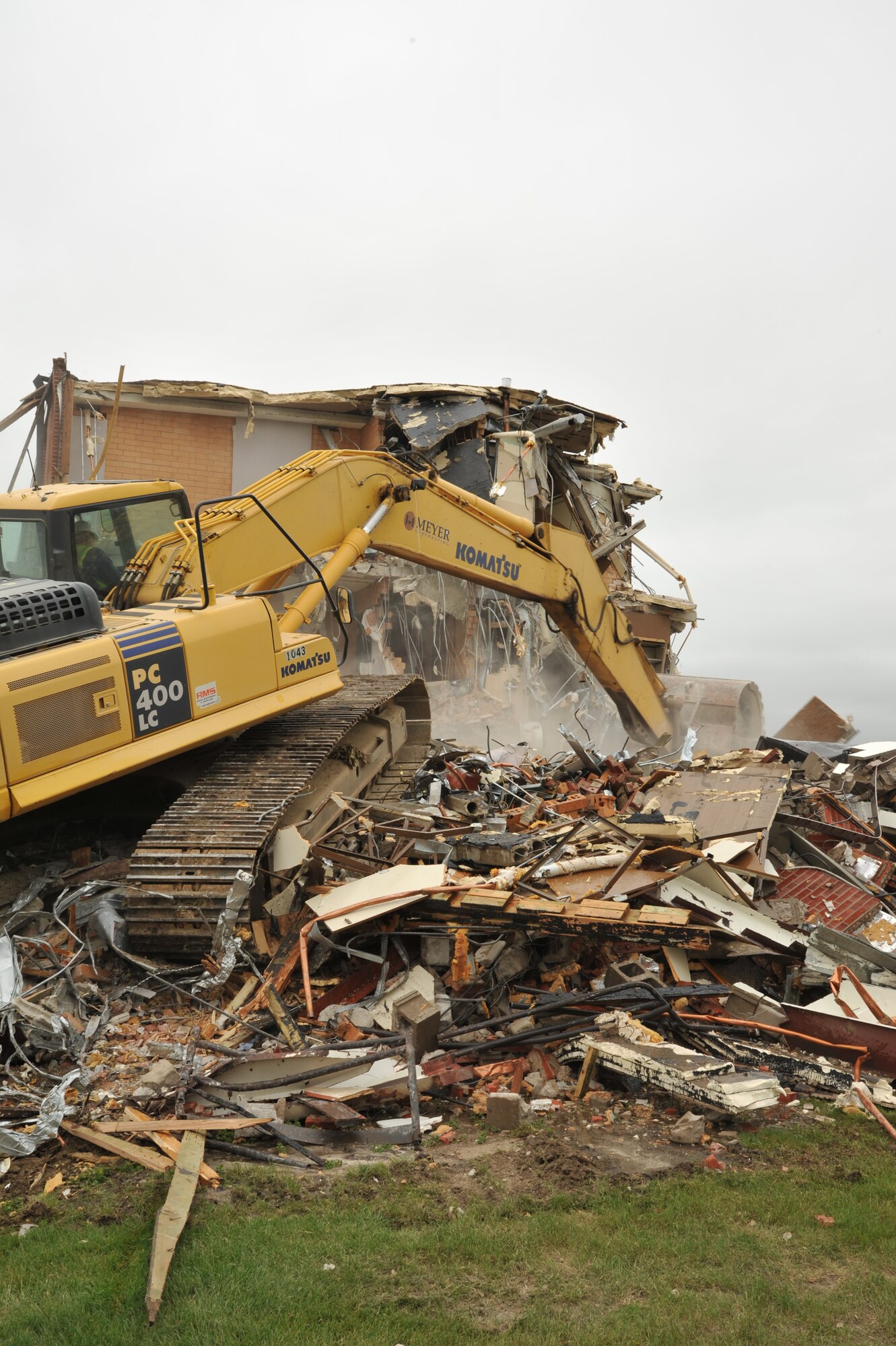 MINOT AIR FORCE BASE, N.D. -- With the help of heavy excavating equipment, construction crew members had their work cut out for them as they worked to tear down an old dorm here in order to make way for a new one June 19. To accommodate the need for a growing work force at Minot AFB, personnel have long been coordinating efforts to build a fourth new dorm which also works towards improving Airmen's quality of life. (U.S. Air Force photo/Airman 1st Class Andrew Crawford)