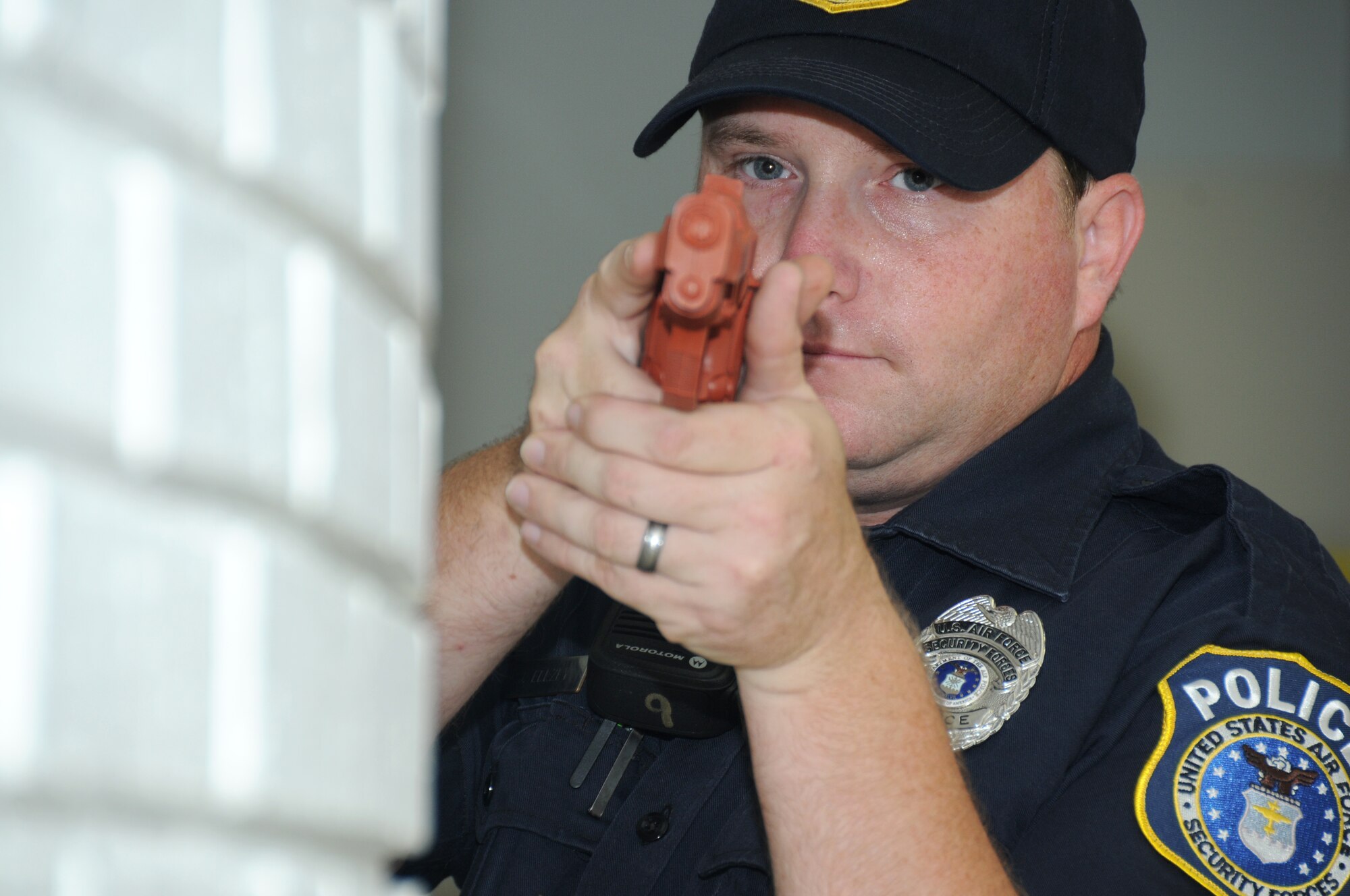 Officer Jeremy Ellzey, 81st Security Forces Squadron, sweeps the facility for the gunman during Keesler's active shooter exercise, June 12, 2012, at the Arnold Annex, Keesler Air Force Base, Miss. The two-day exercise consisted of a lone gunman opening fire with four people killed and 32 injured. The exercise tested the base's ability to respond and recover from a mass casualty event.  (U.S. Air Force photo by Kemberly Groue)