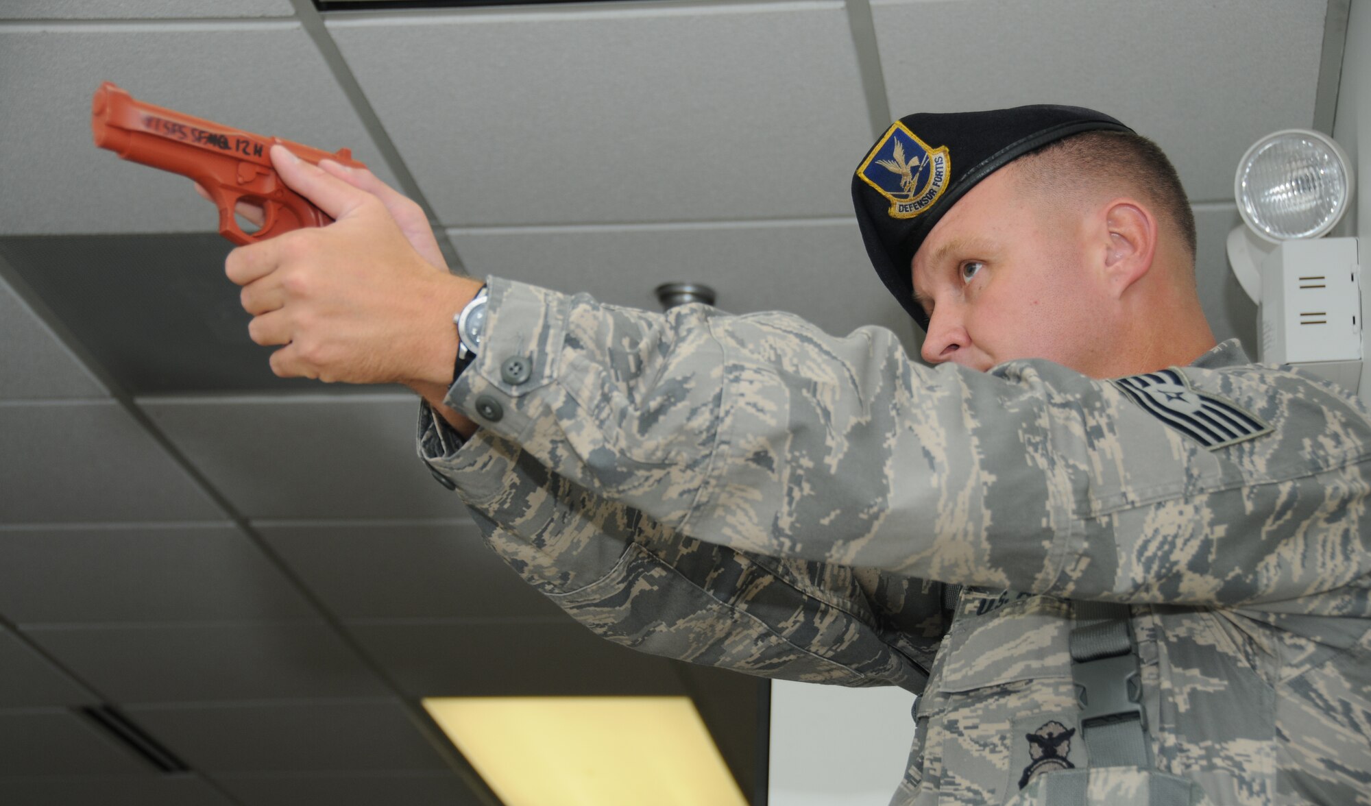 Tech. Sgt. Aaron Gaddis, 81st Security Forces Squadron, sweeps the facility for the gunman during Keesler's active shooter exercise, June 12, 2012, at the Arnold Annex, Keesler Air Force Base, Miss. The two-day exercise consisted of a lone gunman opening fire with four people killed and 32 injured. The exercise tested the base's ability to respond and recover from a mass casualty event.  (U.S. Air Force photo by Kemberly Groue)