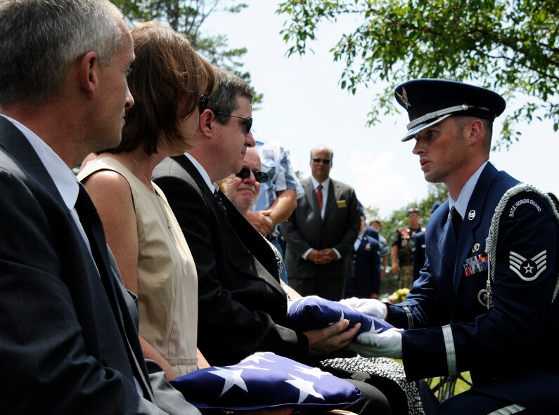 A Little Rock Air Force Base honor guardsman presents a Unites States flag to the family of Capt. Virgil Meroney III during a repatriation ceremony held in Fayetteville, Ark., June 9, 2012. Meroney was missing in action during the Vietnam War after being shot down in his F-4D Phantom II aircraft, which crashed while carrying out a nighttime strike mission in Kahammouan Province, Laos. Meroney’s remains were identified May 24 and were returned to his family for burial with full military honors. Four A-10C Thunderbolt II “Warthogs” with the Arkansas Air National Guard’s 188th Fighter Wing also performed a missing man formation during a flyover at the ceremony to honor Meroney. (National Guard photo by Airman 1st Class Hannah Landeros/188th Fighter Wing Public Affairs)
