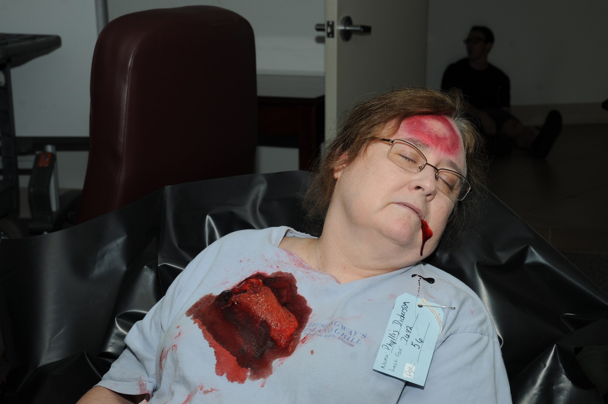 Phyllis Dickerson, 81st Medical Group, portrays a wounded victim during Keesler's active shooter exercise, June 12, 2012, at the Arnold Annex, Keesler Air Force Base, Miss. The two-day exercise consisted of a lone gunman opening fire with four people killed and 32 injured. The exercise tested the base's ability to respond and recover from a mass casualty event. (U.S. Air Force photo by Kemberly Groue)