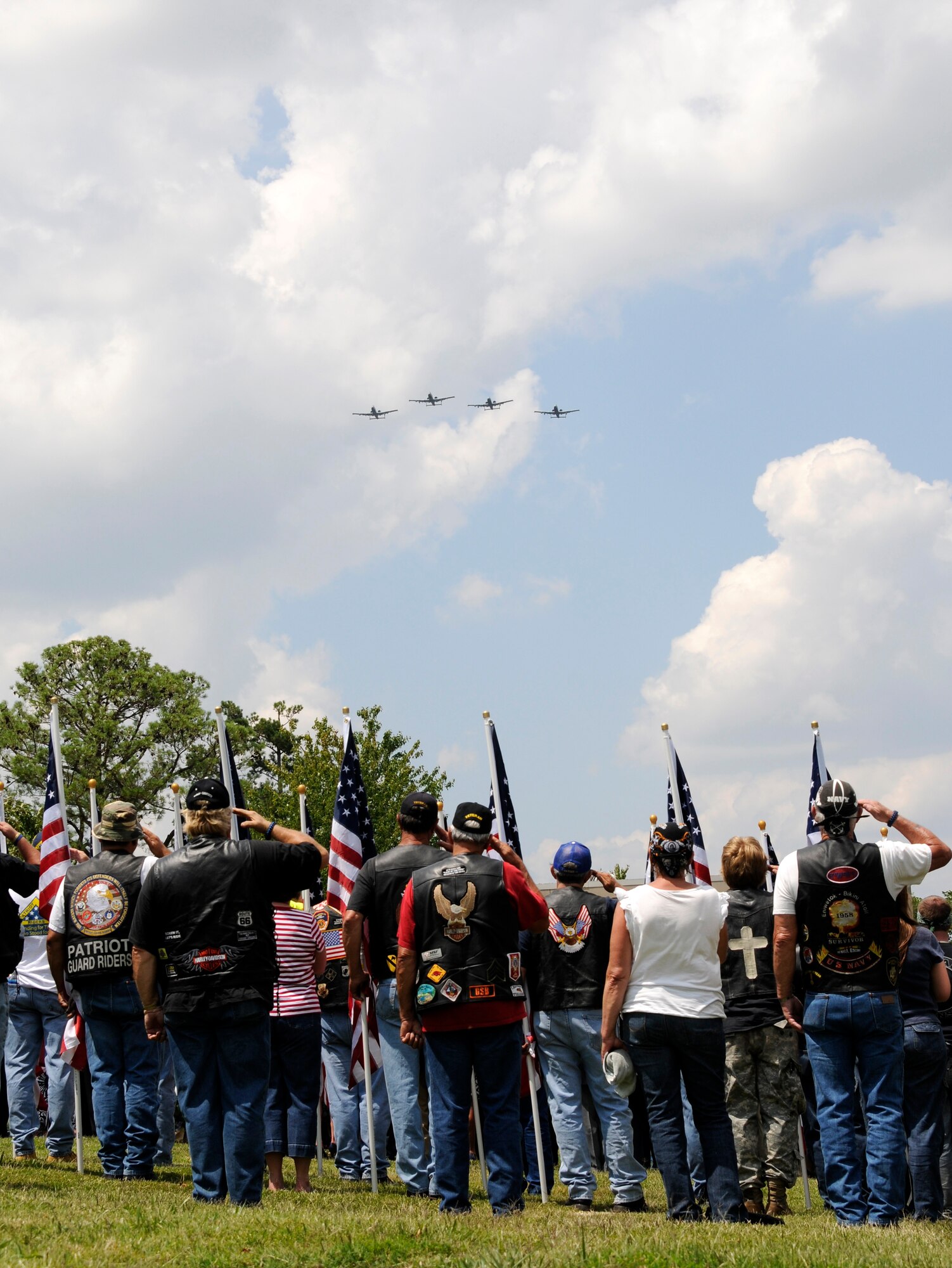 Members of the Patriot Guard salute as a four-ship of A-10C Thunderbolt II “Warthogs” with the Arkansas Air National Guard’s 188th Fighter Wing perform a missing man formation during a flyover to honor Capt. Virgil Meroney III during a repatriation ceremony held in Fayetteville, Ark., June 9, 2012. Meroney was missing in action during the Vietnam War after being shot down in his F-4D Phantom II aircraft, which crashed while carrying out a nighttime strike mission in Kahammouan Province, Laos. Meroney’s remains were identified May 24 and were returned to his family for burial with full military honors. (National Guard photo by Airman 1st Class Hannah Landeros/188th Fighter Wing Public Affairs)