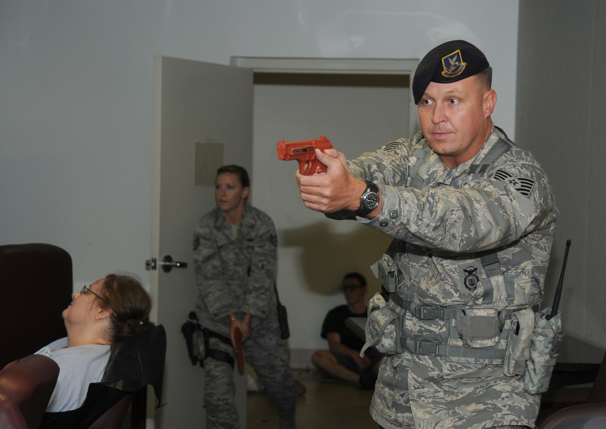 Staff Sgt. Audrey Spoor and Tech. Sgt. Aaron Gaddis, 81st  Security Forces Squadron, engage and neutralize the gunman ending his shooting spree during an active shooter exercise, June 12, 2012, at the Arnold Annex, Keesler Air Force Base, Miss. The two-day exercise consisted of a lone gunman opening fire with four people killed and 32 injured. The exercise tested the base's ability to respond and recover from a mass casualty event. (U.S. Air Force photo by Kemberly Groue)