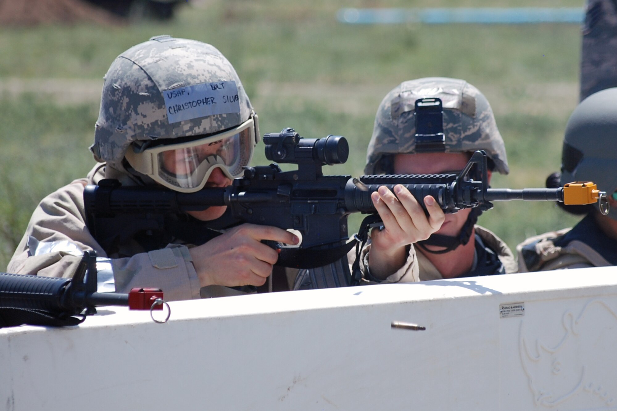 Members of the 21st Space Wing practice defending against enemy fire as part of a deployment scenario June 14 and 15. Approximately 104 Airmen spent two days training in chemical warfare, weapons firing and weapon maintenance during the Condor Crest exercise. (U.S. Air Force photo/Lea Johnson)