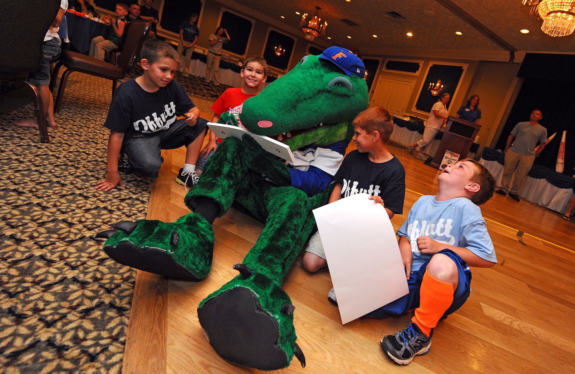 Albert, the University of Florida's mascot, signs autographs for kids at the Patriot Club June 17 at Offutt Air Force Base, Neb.  Albert, along with the Gators baseball team, toured the 55th Wing as a sponsored team for the 2012 College World Series.  (U.S. Air Force photo by Josh Plueger)