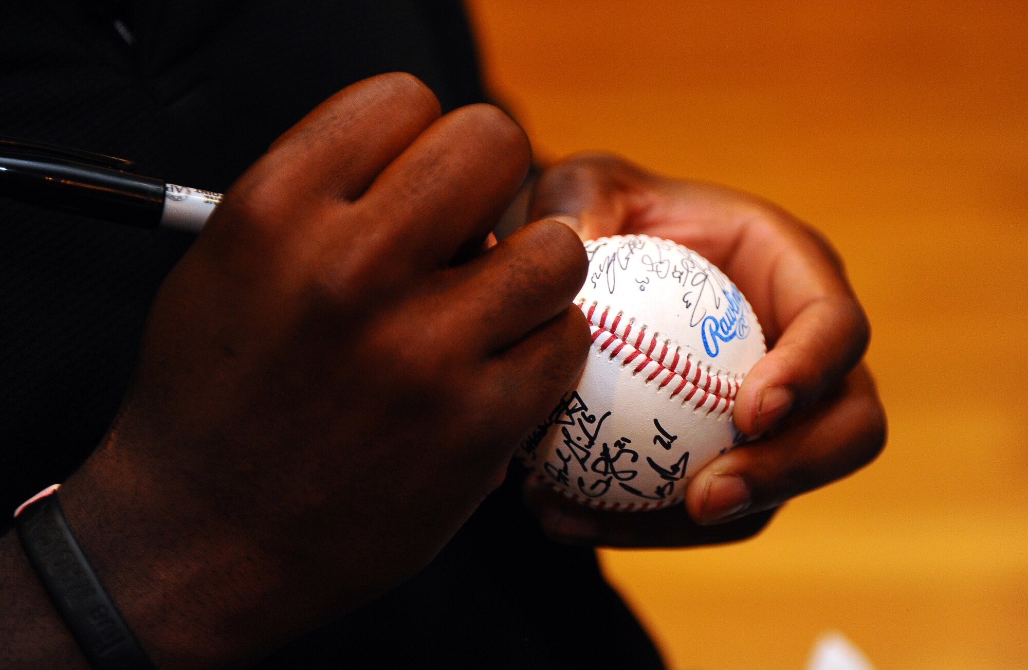 The University of Florida?s baseball team signs autographed baseballs for those lucky few individuals that got to have a buffet dinner with them in the Patriot Club June 17 at Offutt Air Force Base, Neb.  The Gators got an exclusive tour of the wing prior to eating dinner at the Patriot Club. (U.S. Air Force photo by Josh Plueger)
