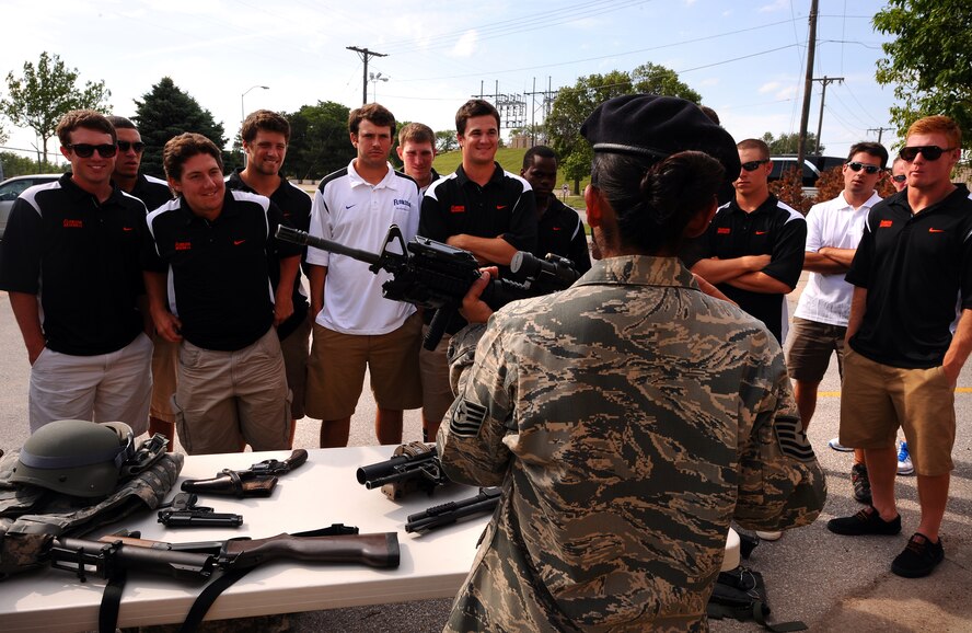 U.S. Air Force Tech. Sgt. Tracy Howard, 55th Security Forces Squadron, showcases the arsenal of weaponry used by the men and women of the 55th SFS for the University of Florida's Baseball team June 17 on Offutt Air Force Base, Neb.  The Gators were in the Omaha metro area to compete in the 2012 College World Series.  (U.S. Air Force photo by Josh Plueger)