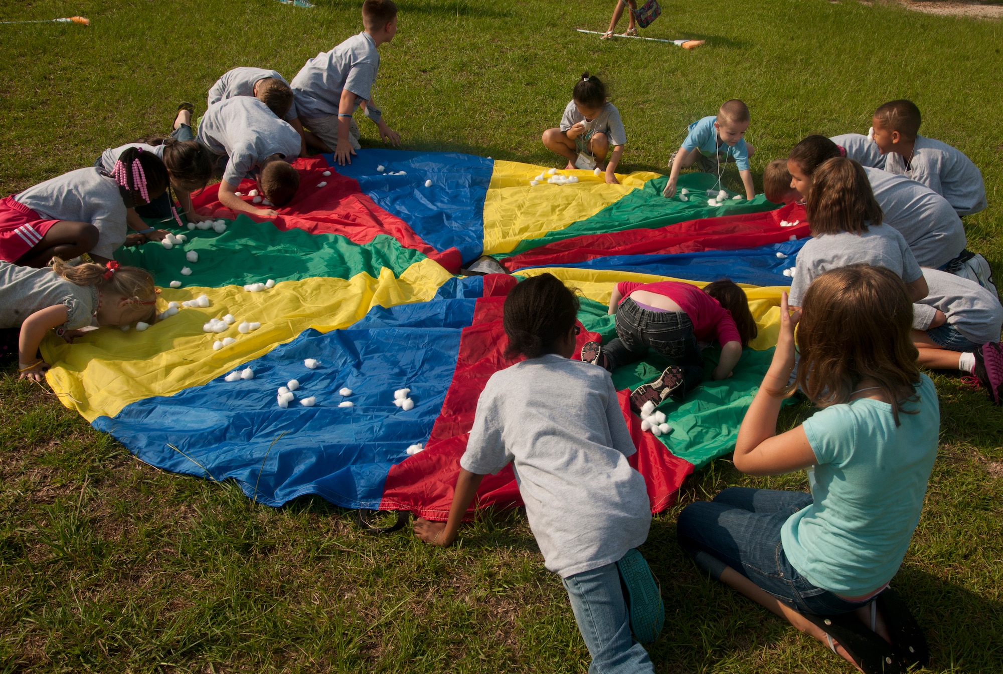 Children of the Sky Vacation Bible School work together during a game at Moody Air Force Base, Ga., June 14, 2012. The game helped build teamwork among the children as they collected as many cotton balls with their noses in the fastest time. (U.S. Air Force photo by Airman 1st Class Paul Francis/Released)

