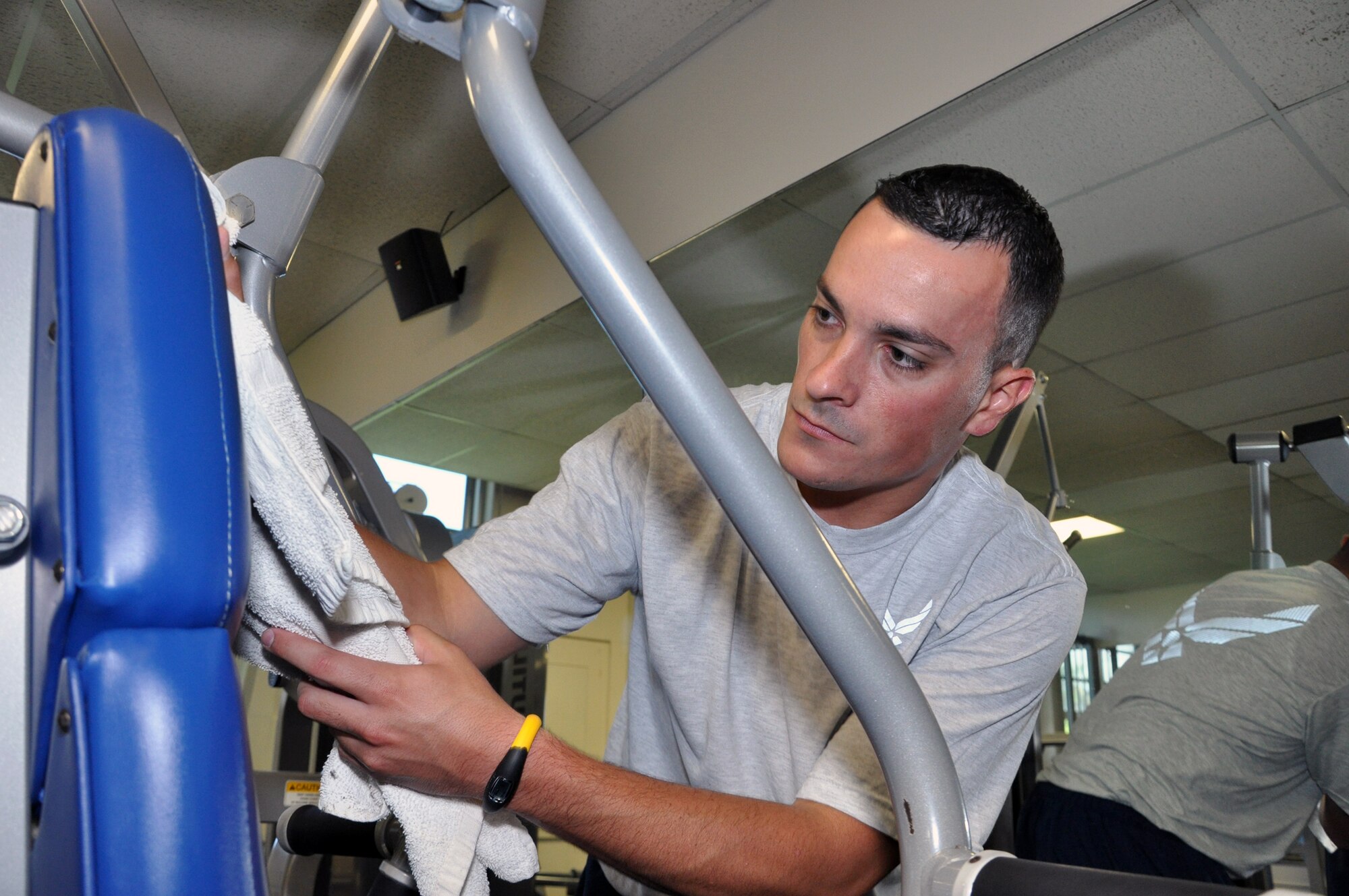 JOINT BASE PEARL HARBOR-HICKAM, Hawaii -- Staff. Sgt. Jon Summers II, 442nd Force Support Squadron services technician, sanitizes workout equipment at the installation's fitness center. Summers is one of approximately 30 Services Flight Airmen on temporary duty working and training in various positions on base. The 442nd Force Suport Squadron is part of the 442nd FW, an A-10 Thunderbolt II Reserve unit at Whiteman Air Force Base, Mo. (U.S. Air Force photo/Senior Airman Wesley Wright)