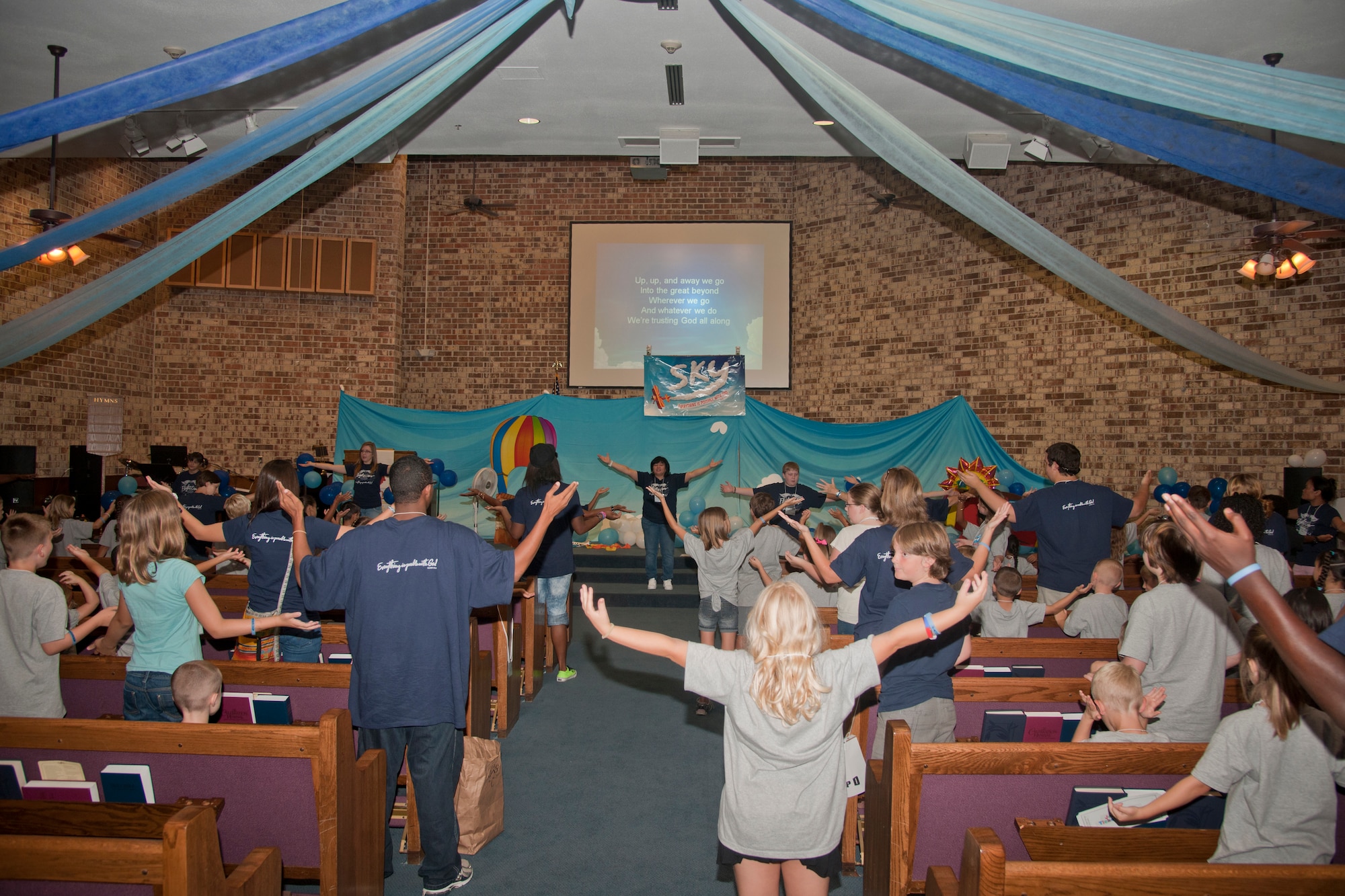 Children attending the Fly Vacation Bible School dance and sing in the chapel before transitioning to different classrooms at Moody Air Force Base, Ga., June 14, 2012. The purpose of VBS is to teach basic biblical principals into the lives of military children and to provide a safe nurturing place for children to learn through play, fellowship and song. (U.S. Air Force photo by Airman 1st Class Paul Francis/Released)
