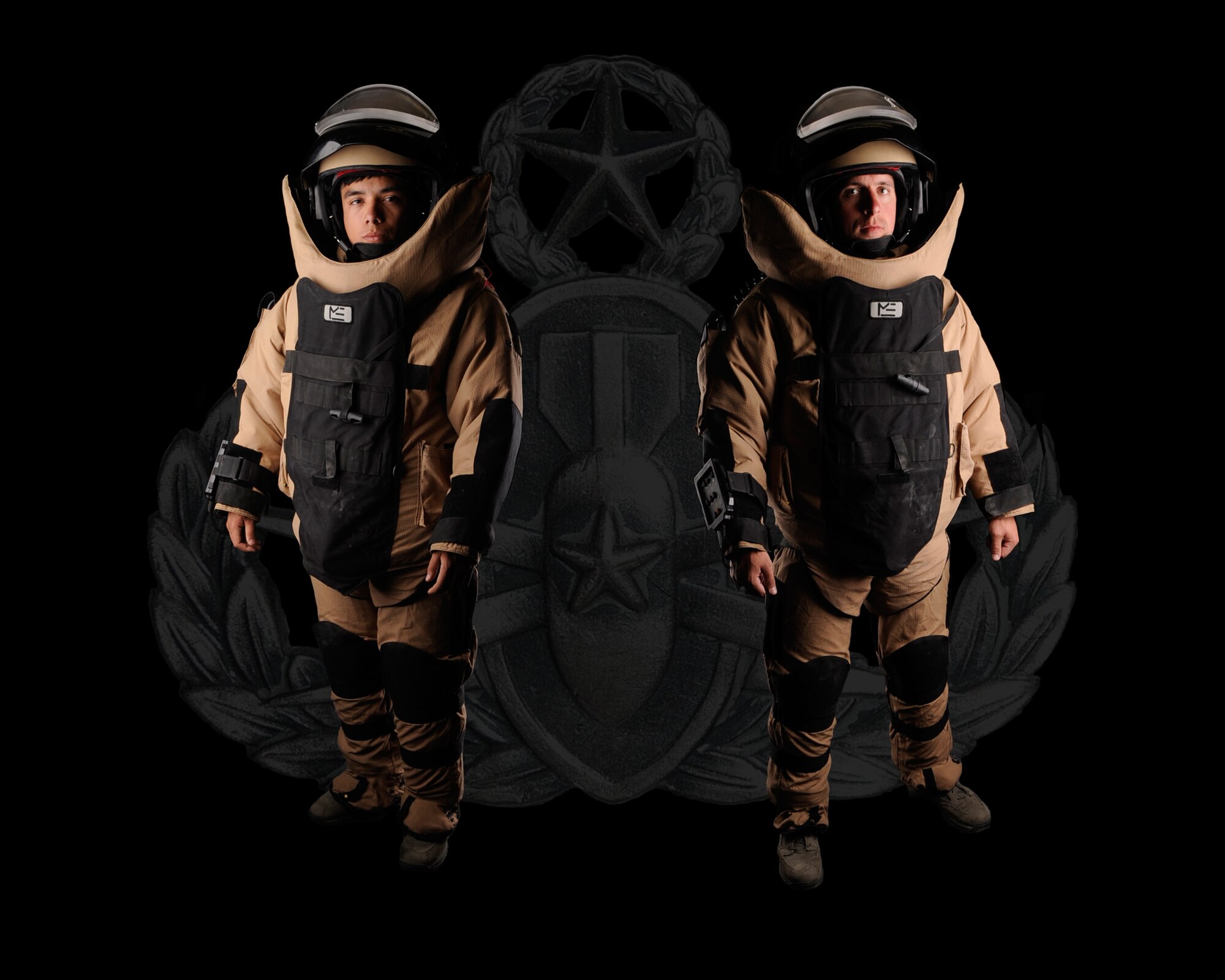 U.S. Air Force Airman 1st Class Gabriel Kalohelani, 366th Civil Engineer Squadron explosive ordnance disposal apprentice, and Staff Sgt. Jonathan Winter, 366th CES EOD journeyman, display the EOD-9 Bomb Suit, June 14, 2012, at Mountain Home Air Force Base, Idaho, after being a part of a Presidential detail which helps ensure the area around the president is free of explosive ordnance. Winter and Kalohelani have worked the presidential detail together and coincidentally it was the seventh time for each Airman individually. (U.S. Air Force photo illustration/ Airman 1st Class Jonathan Glanville)