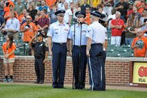 Members of the United States Air Force Academy Band sing the National Anthem June 13, 2012, in front of a crowd of 23, 238 fans at Oriole Park at Camden Yards, Md. The bandsmen perform at numerous locations worldwide in an effort to project a positive Air Force image through music. (U.S. Coast Guard photo by Petty Officer 3rd Class Matthew Masaschi)