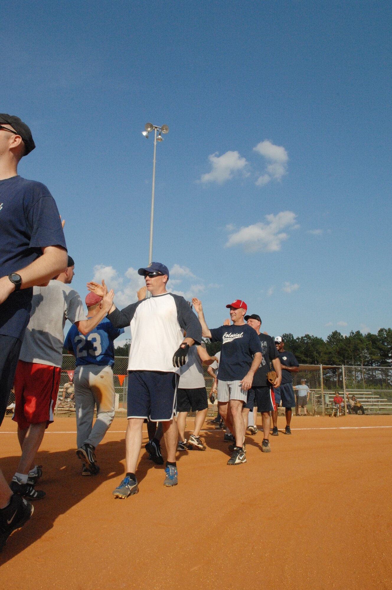 U.S. Air Force Chief master sergeants. and colonels finish the Chiefs vs. Eagles softball game with high fives at Shaw Air Force Base, S.C., June 18. 2012.  The Chiefs were the 2012 winners.(U.S. Air Force Airman Nicole Sikorski/Released)