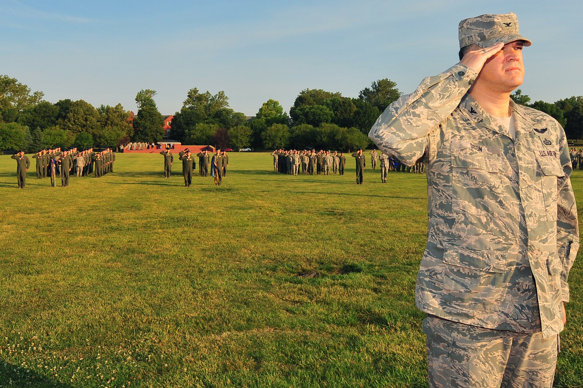 U.S. Air Force Col. Kevin Dixon, 55th Wing vice commander, salutes the U.S. Flag during the Flag Day ceremony held on the parade grounds at Offutt Air Force Base, Neb., June 14. Dixon enables base support to U.S. Strategic Command and 50 associate units, and 57,000 active-duty military and family members, civilian personnel and retirees in the Offutt Air Force Base area. (U.S. Air Force Photo by Charles Haymond/Released)