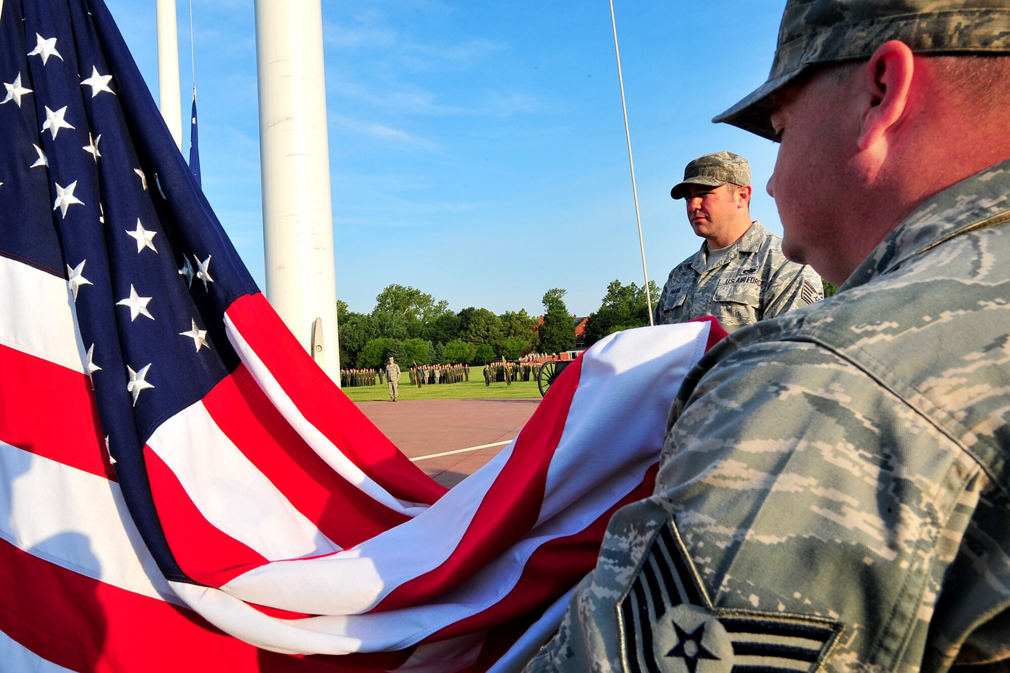 U.S. Air Force Tech. Sgt's. Casey Putney and Jeffrey Haak, both with the 55th Aircraft Maintenance Squadron, hold the U.S. Flag during the Flag Day ceremony held on the parade grounds at Offutt Air Force Base, Neb., June 14. The 55th AMXS generates more than 2,500 sorties a year, providing the world's premier intelligence and command and control capabilities.  It includes 640 military and 109 contract maintainers in 19 Air Force Specialty Codes. (U.S. Air Force Photo by Charles Haymond/Released)