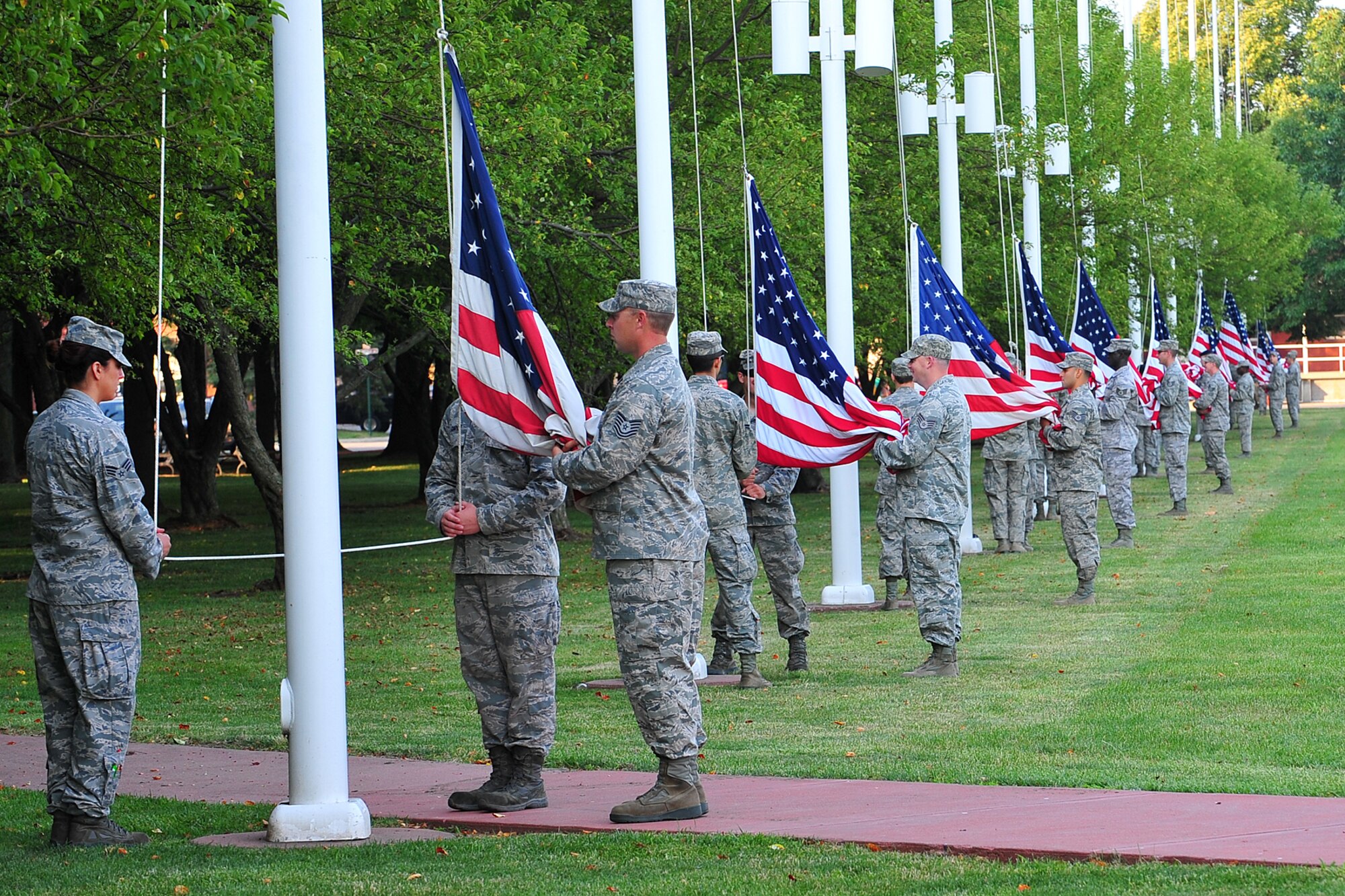 020  Team Offutt members lower the U.S. Flag during the Flag Day ceremony held on the parade grounds at Offutt Air Force Base, Neb., June 14. The "Stars and Stripes," the official National symbol of the United States of America was authorized by congress on Saturday, June 14, 1777 it was the fifth item of the day's agenda. (U.S. Air Force Photo by Charles Haymond/Released)