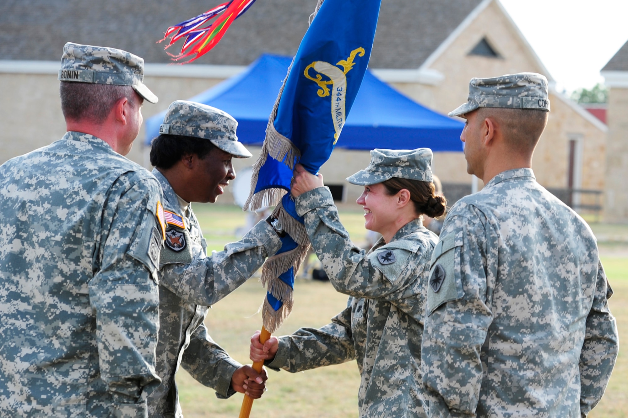 U.S. Army Col. Angelia Farnell, 111th Military Intelligence Brigade commander, passes the 344th Military Intelligence Battalion (MI BN) colors to Lt. Col. Devon Blake at Fort Concho, Texas, June 14, 2012.  Blake assumed command of the 344th MI BN at Goodfellow Air Force Base from Lt. Col. John Bonin during a change of command ceremony.  (U.S. Air Force photo by Staff Sgt. Austin Knox)