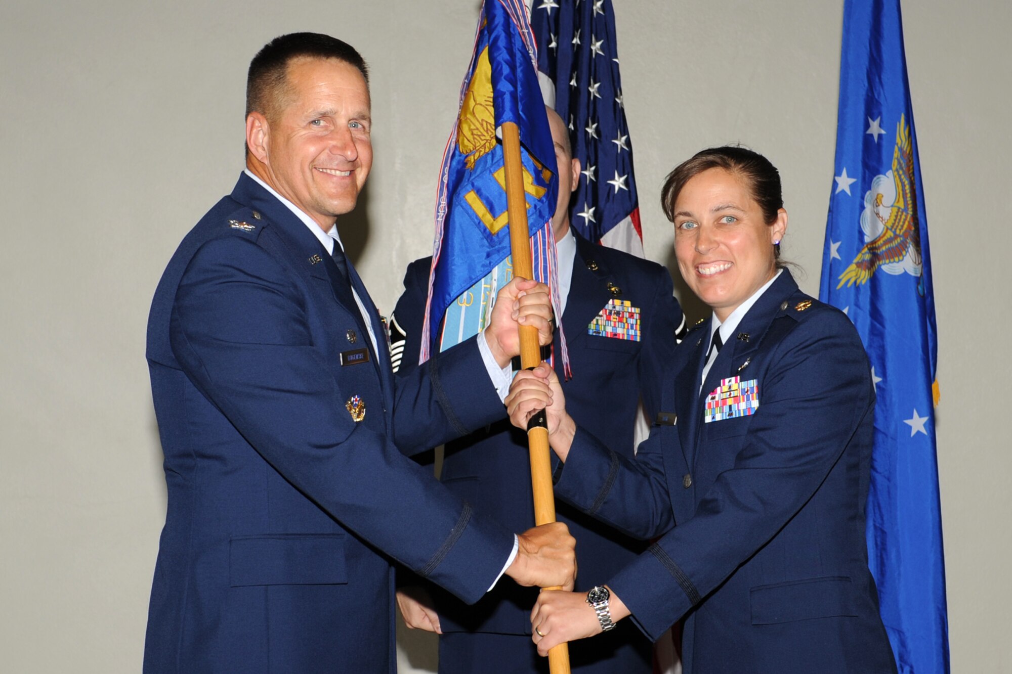 U.S. Air Force Col. Paul Bugenske, 17th Mission Support Group commander, passes the 17th Logistics Readiness Squadron (LRS) guidon to Maj. Lisa Dahl, during a change of command ceremony at Goodfellow Air Force Base, Texas, June 15, 2012. Dahl assumed command of the 17th LRS from Lt. Col. Michael Jones during a change of command ceremony. (U.S. Air Force photo by Staff Sgt. Laura R. McFarlane)  