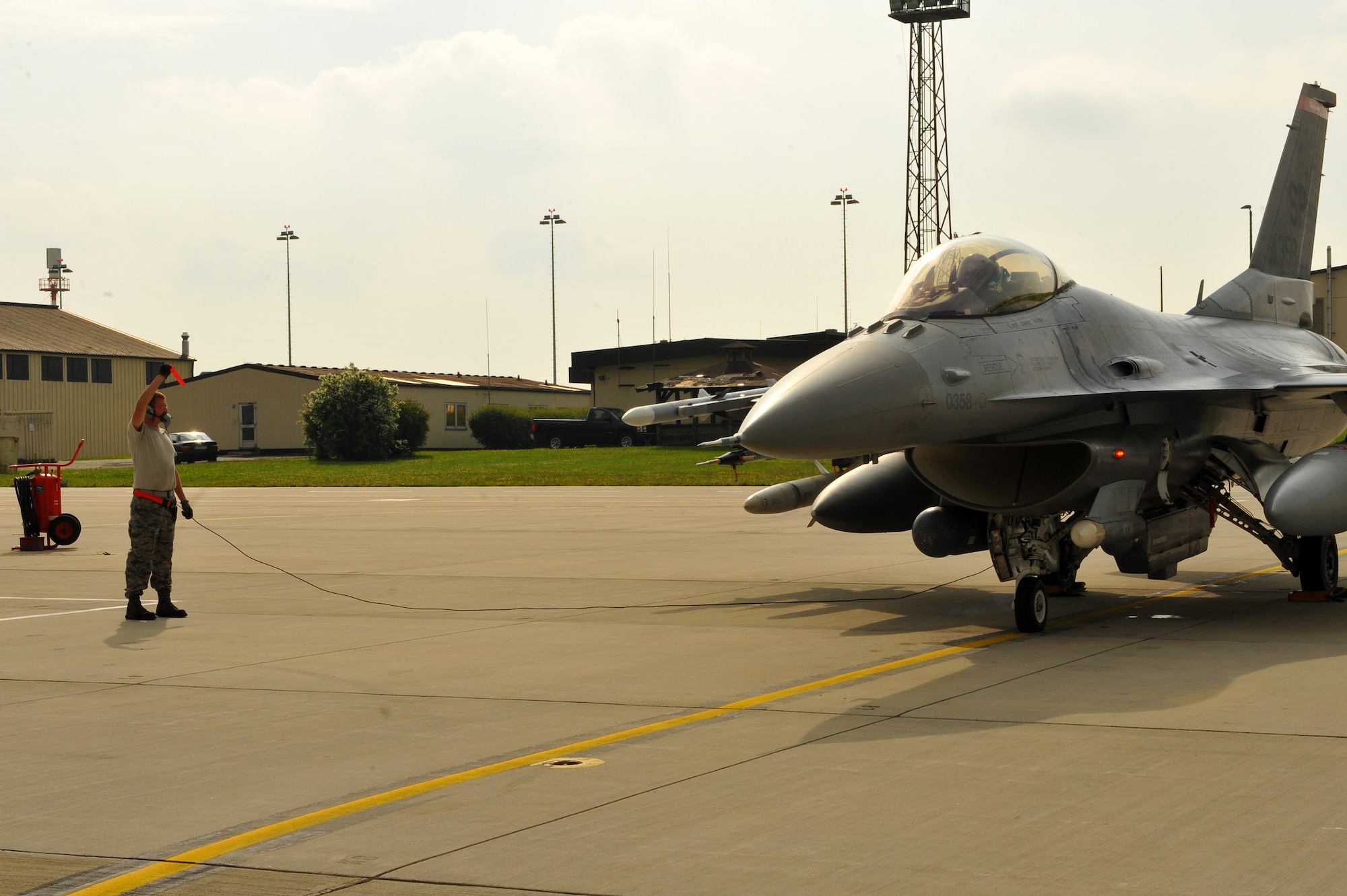 SPANGDAHLEM AIR BASE, Germany – Airman 1st Class Joshua Berard, 480th Aircraft Maintenance Unit crew chief, completes a standard aircraft launch procedure for an F-16 Fighting Falcon on Ramp 4 here June 19. The 480th AMU plays a vital role in supporting the F-16’s combat training mission, which prepares them for regional defense and air superiority. (U.S. Air Force photo by Airman 1st Class Dillon/Released)