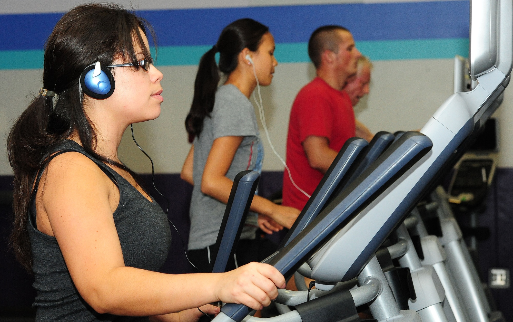 WHITEMAN AIR FORCE BASE, Mo. -- Charlynne Garcia, 509th Maintenance Group secretary, works out on an elliptical machine at the Whiteman Fitness Center June 6. Instead of running outside during extremely hot weather conditions, it is recommended for individuals to run or do cardio indoors to avoid heat-related injuries, according to Tech. Sgt. Tara Lee, 509th Medical Operations Squadron NCO in charge of force health management. (U.S. Air Force photo/Senior Airman Nick Wilson) (Released)