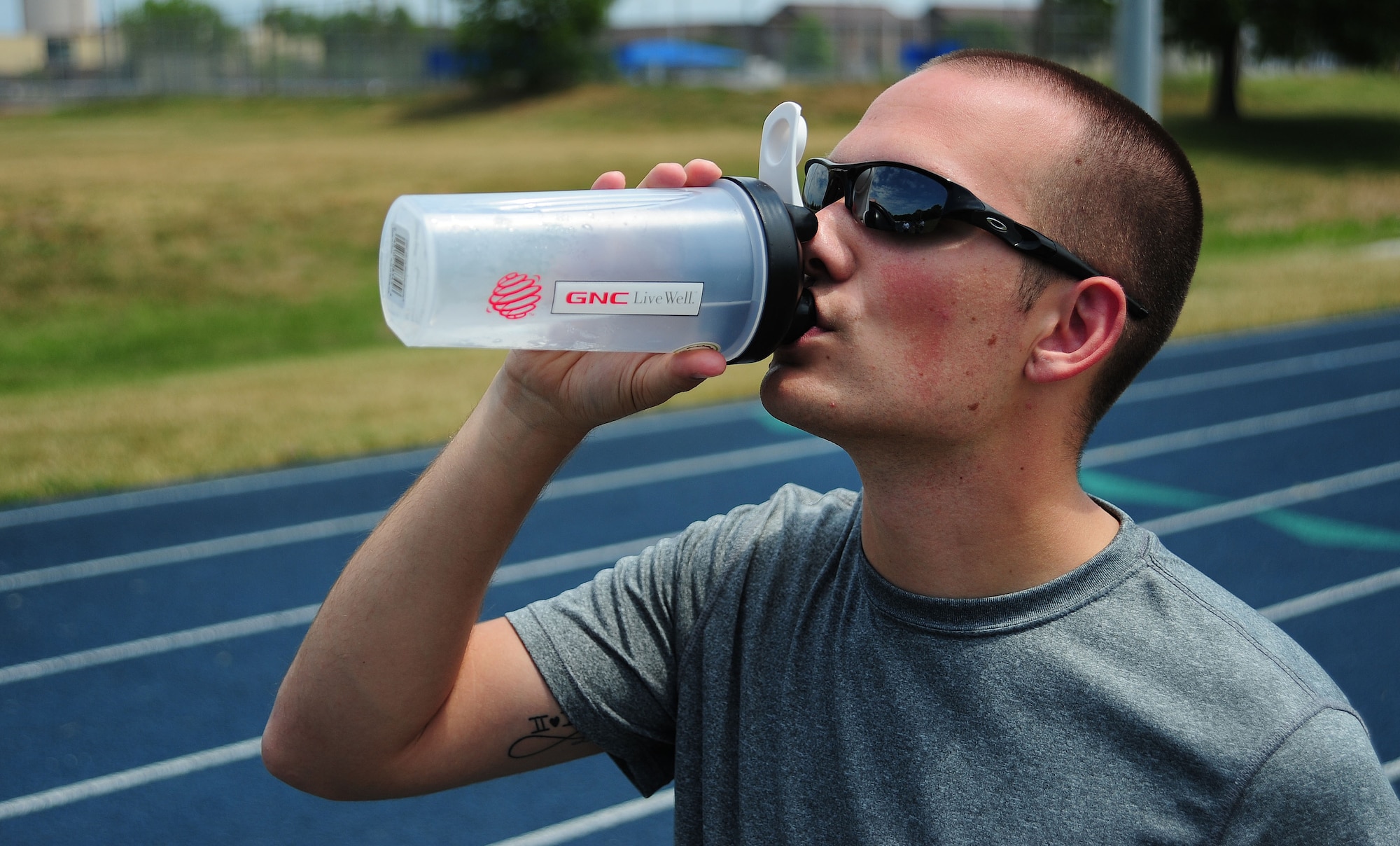 WHITEMAN AIR FORCE BASE, Mo. -- Airman 1st Class Joshua Sawdy, 509th Comptroller Squadron financial management comptroller, hydrates after a run June 6. Because more than half of the human body is comprised of water, it is the most essential fluid, according to the American College of Sports Medicine website. (U.S. Air Force photo/Senior Airman Nick Wilson) (Released)