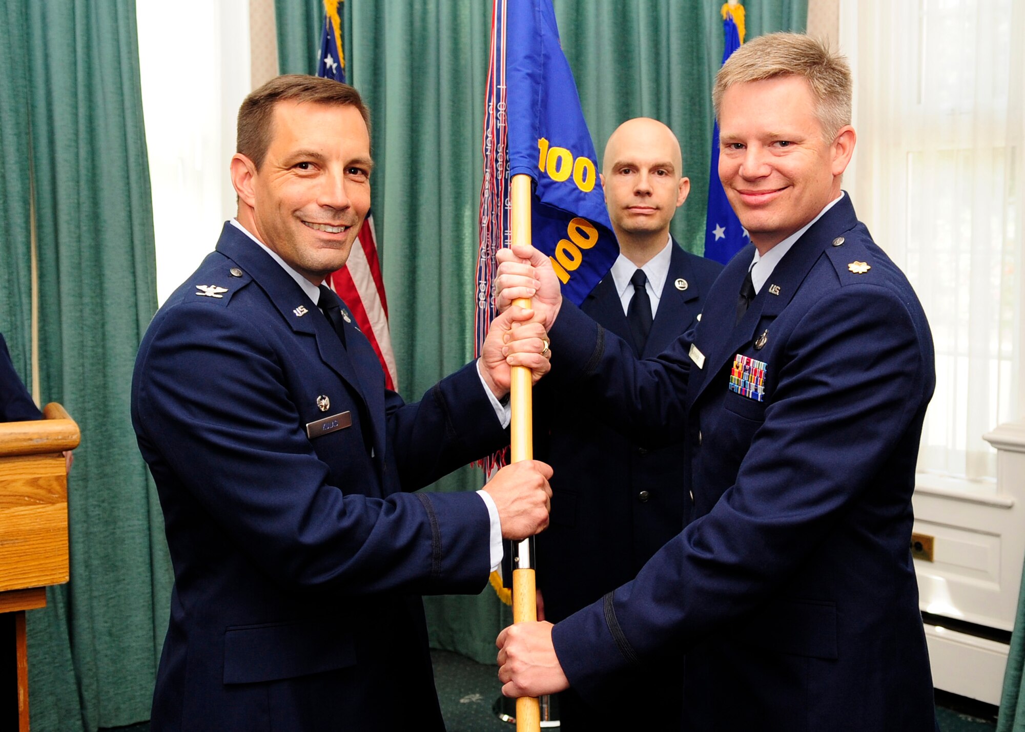 RAF MILDENHALL, England – Maj. Charles Barkhurst, (right) 100th Comptroller Squadron commander, accepts the 100th CPTS’s guidon from Col. Christopher Kulas, (left) 100th Air Refueling Wing commander, during the 100th CPTS change of command at Middleton Hall June 19, 2012. Barkhurst receives the guidon to symbolize his accepting command of the 100th CPTS. (U.S. Air Force photo/Senior Airman Ethan Morgan)