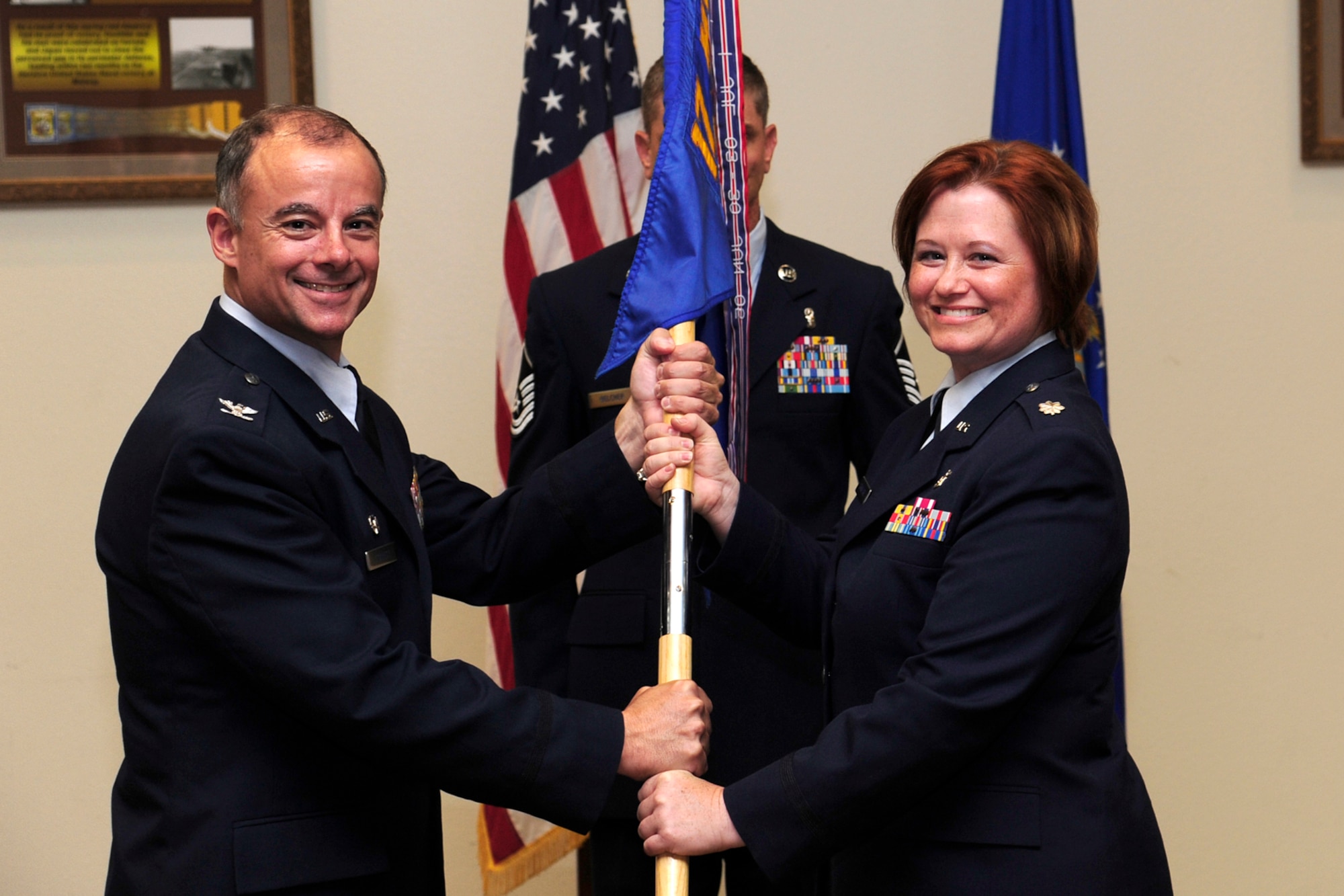 U.S. Air Force Col. James Forrest, 17th Medical Group commander, passes the 17th Medical Support Squadron (MDSS) guidon to Lt. Col. Krissa Crawford  at Goodfellow Air Force Base, Texas, June 14, 2012.  Crawford  assumed command of the 17th MDSS from Lt. Col. Tyler W. Sanders during a change of command ceremony.  (U.S. Air Force photo by Staff Sgt. Austin Knox)