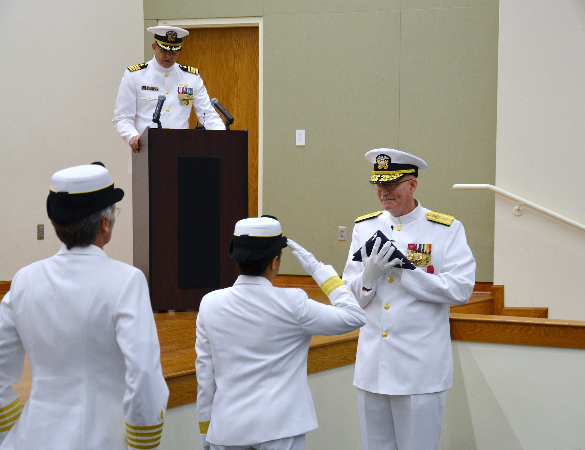 Joint Base San Antonio-Fort Sam Houston, Texas,  Rear Adm. Eleanor Valentin, Commander, Navy Medicine Support Command and Director, Navy Medical Service Corps renders a salute after presenting the flag to Rear Adm. Bob Kiser during his retirement ceremony June 15. Kiser, the first commandant of the Medical Education and Training Campus, retired after 38 years of combined reserve and active duty service. (U.S. Navy photo by Lisa Braun/released)