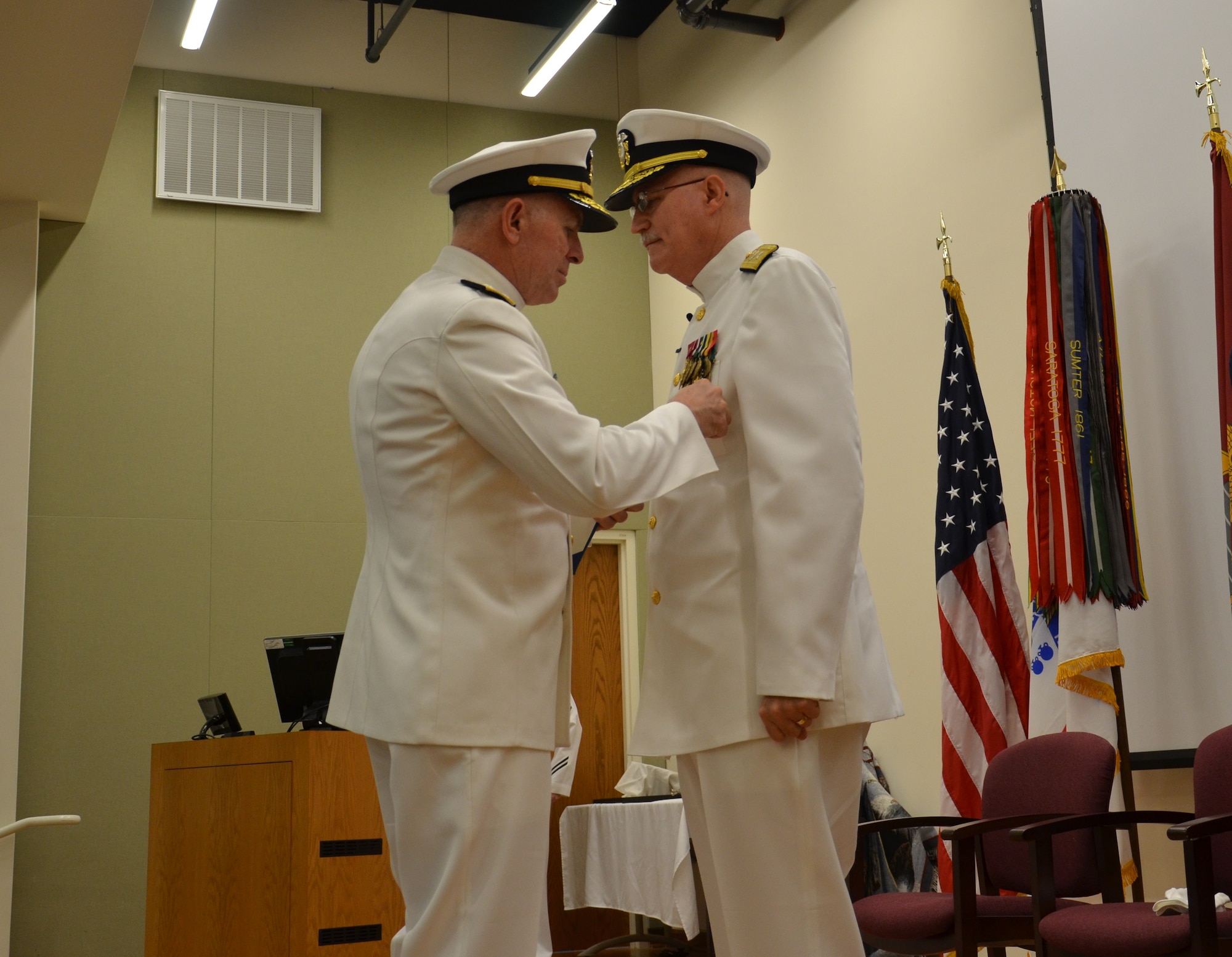 Joint Base San Antonio-Fort Sam Houston, Texas,  Vice Adm. Matthew Nathan, surgeon general of the Navy, and Bureau of Medicine and Surgery chief, awards the Legion of Merit to Rear Adm. Bob Kiser during his retirement ceremony June 15. Kiser, the first commandant of the Medical Education and Training Campus, retired after 38 years of combined reserve and active duty service. (U.S. Navy photo by Lisa Braun/released)