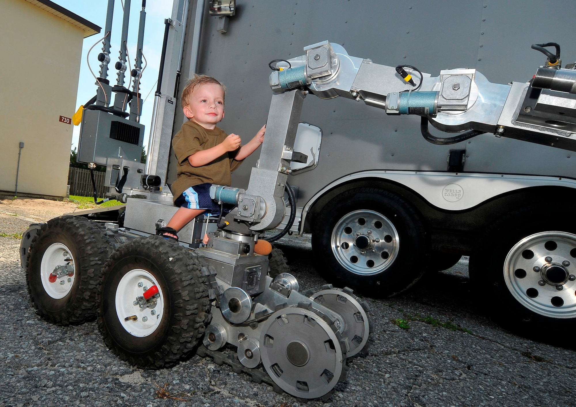 Jaxson takes an interest in the 325th Civil Engineer Squadron Explosive Ordinance Disposal unit's robot, F-6A. He also toured the MRAP All-Terrain vehicle and the armored humvee. Jaxson was born with Russell-Silver syndrome, a genetic growth disorder characterized by slow growth before and after birth. (U.S. Air Force photo by Chris Cokeing)