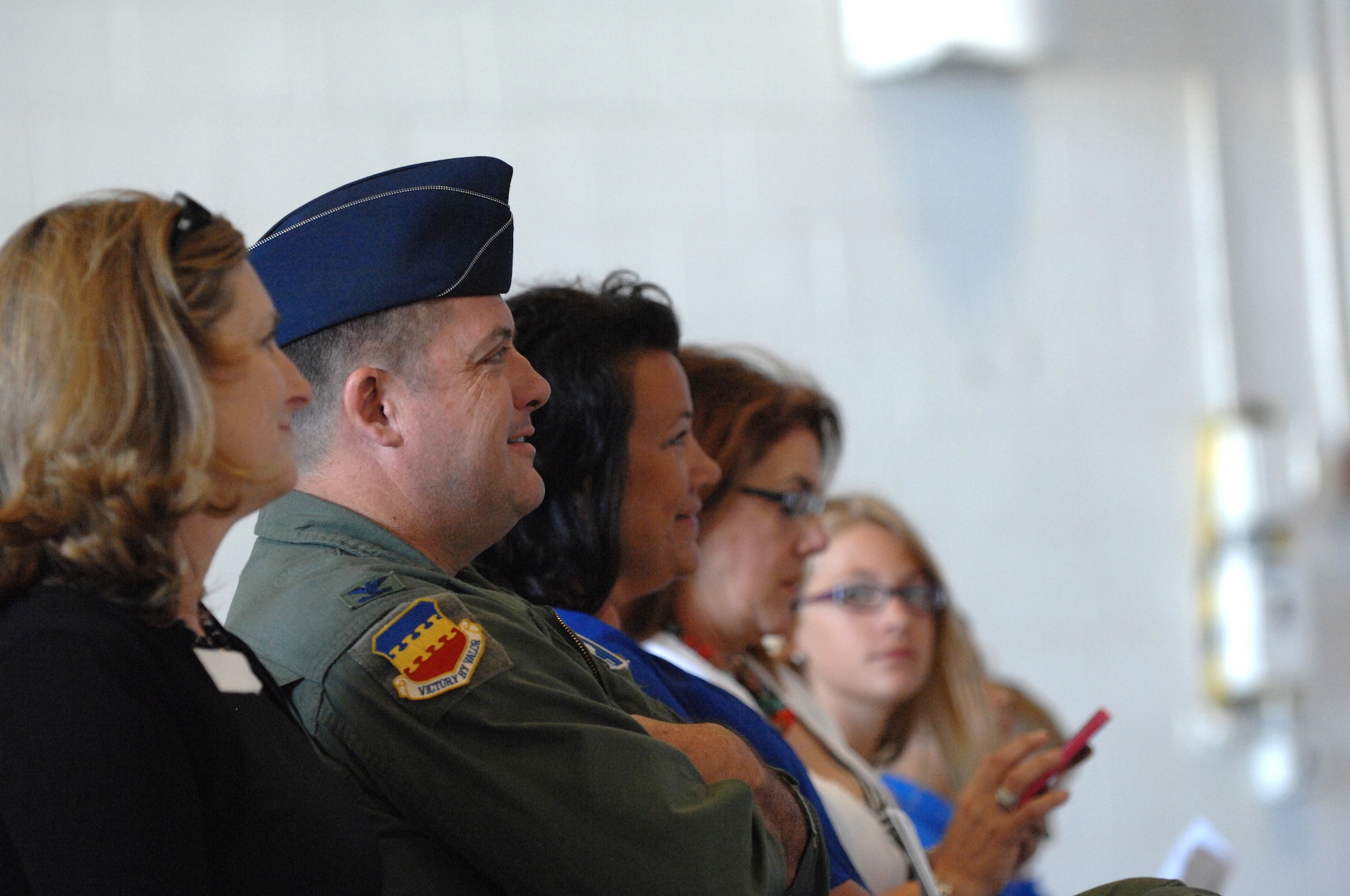 U.S. Air Force Col. Don Godier, 20th Fighter Wing vice commander and the family the new 55th Fighter Squadron "Shooters" commander, Lt. Col. Christopher Claus, attend the 55th FS change of command ceremony at Shaw Air Force Base, S.C., June 15, 2012. Claus assumed command in place of Lt. Col. Micheal Schnabel, 55th Fighter Squadron prior commander.(U.S. Air Force Airman Nicole Sikorski/Released)
